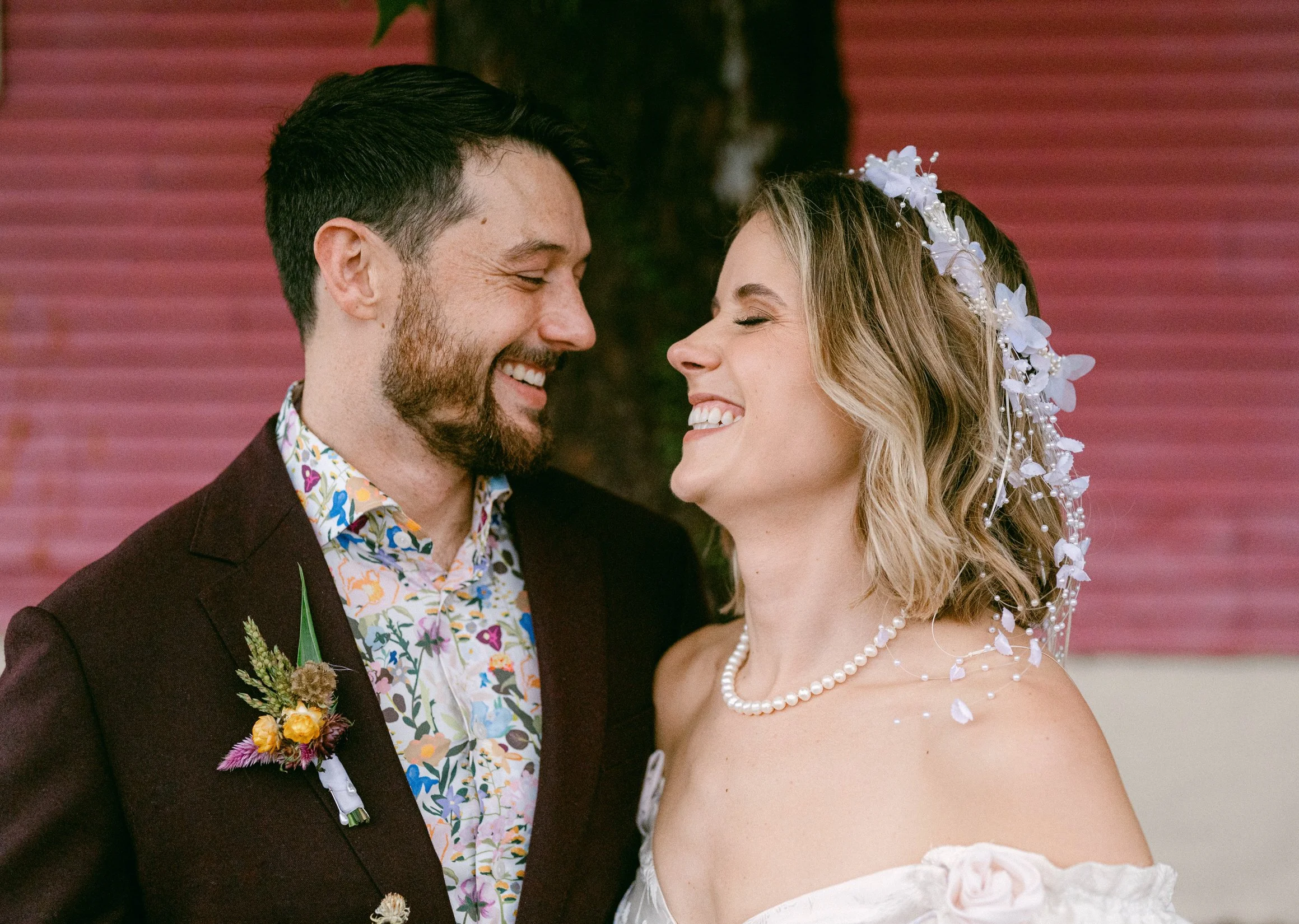 A smiling couple on their wedding day standing close together.
