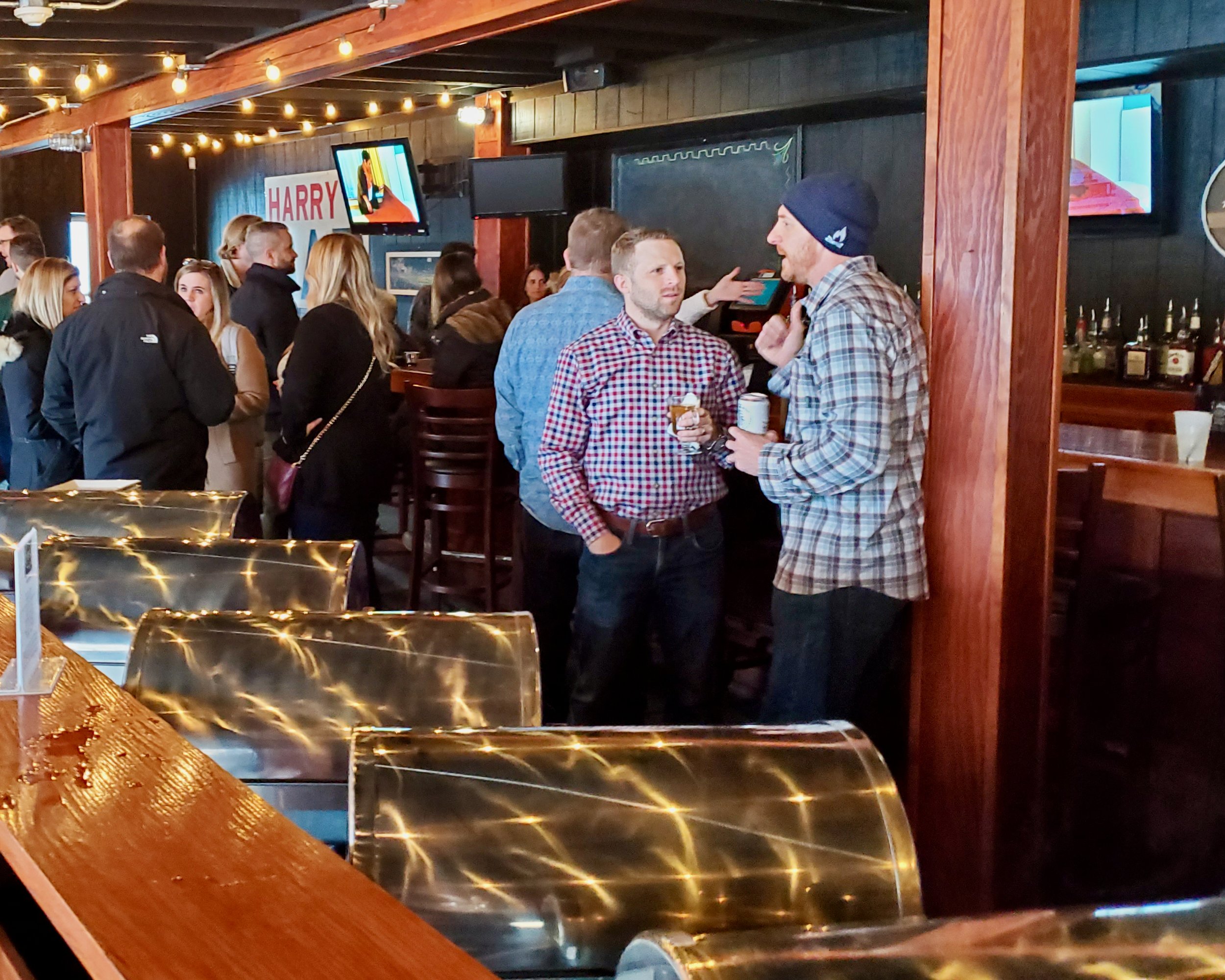 Attendees conversing at a corporate event at Harry's Detroit Bar &amp; Grill