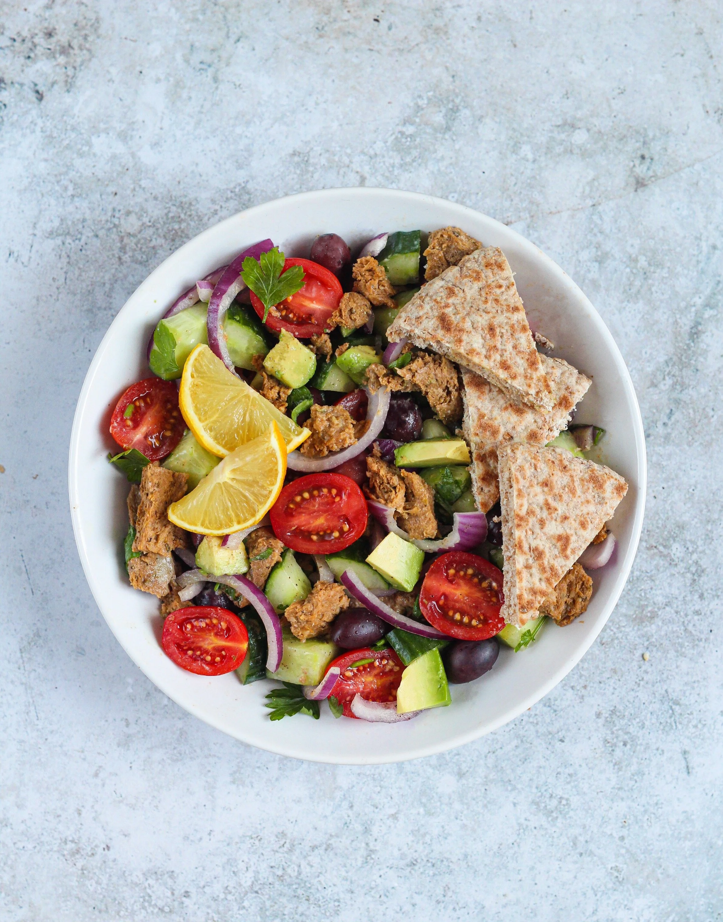 Greek salad with kalamata olives and whole-wheat pita
