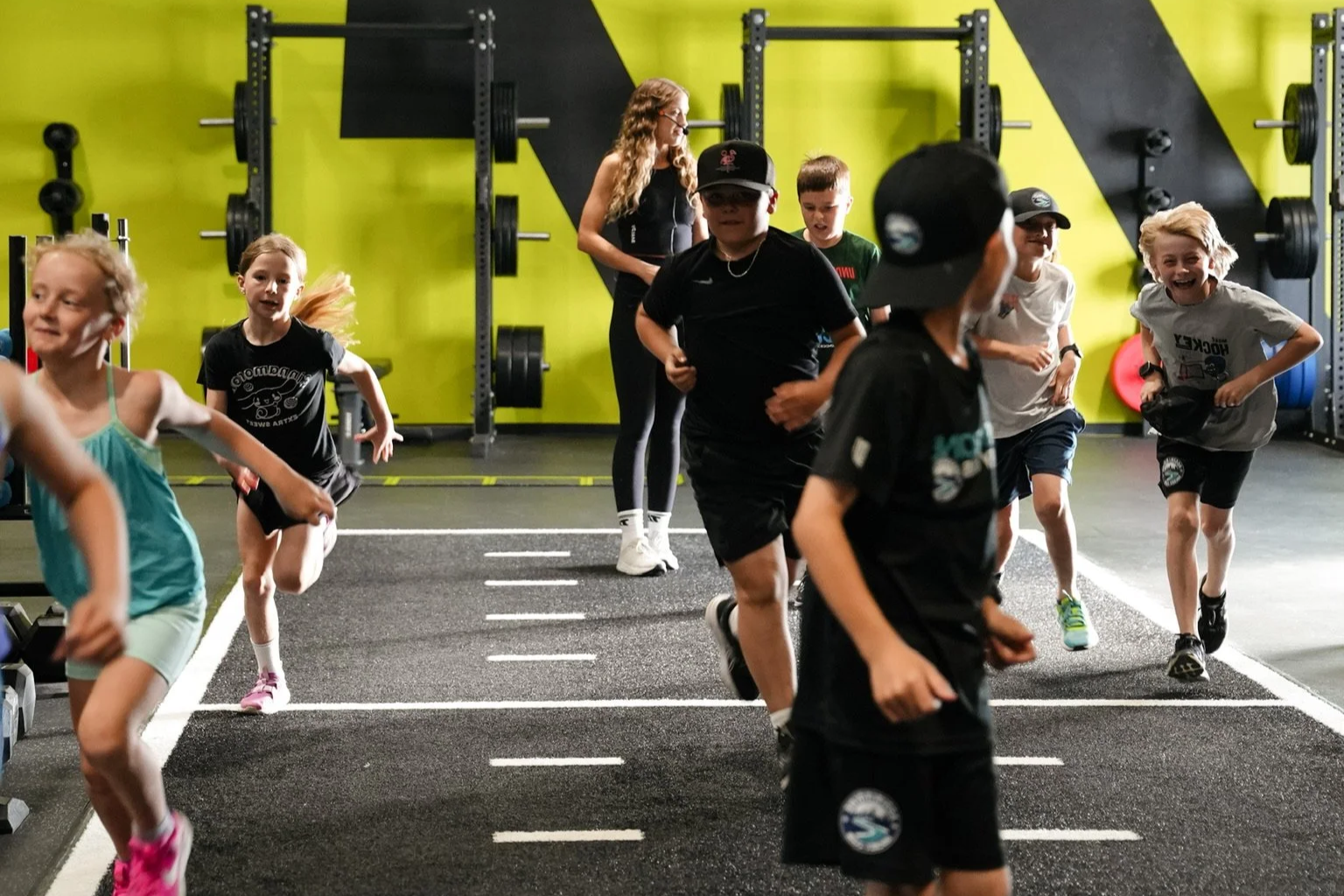 Kids ages 9-12 participating in the Learn to Move youth athletic development kids fitness program at Thrive Active gym facility.