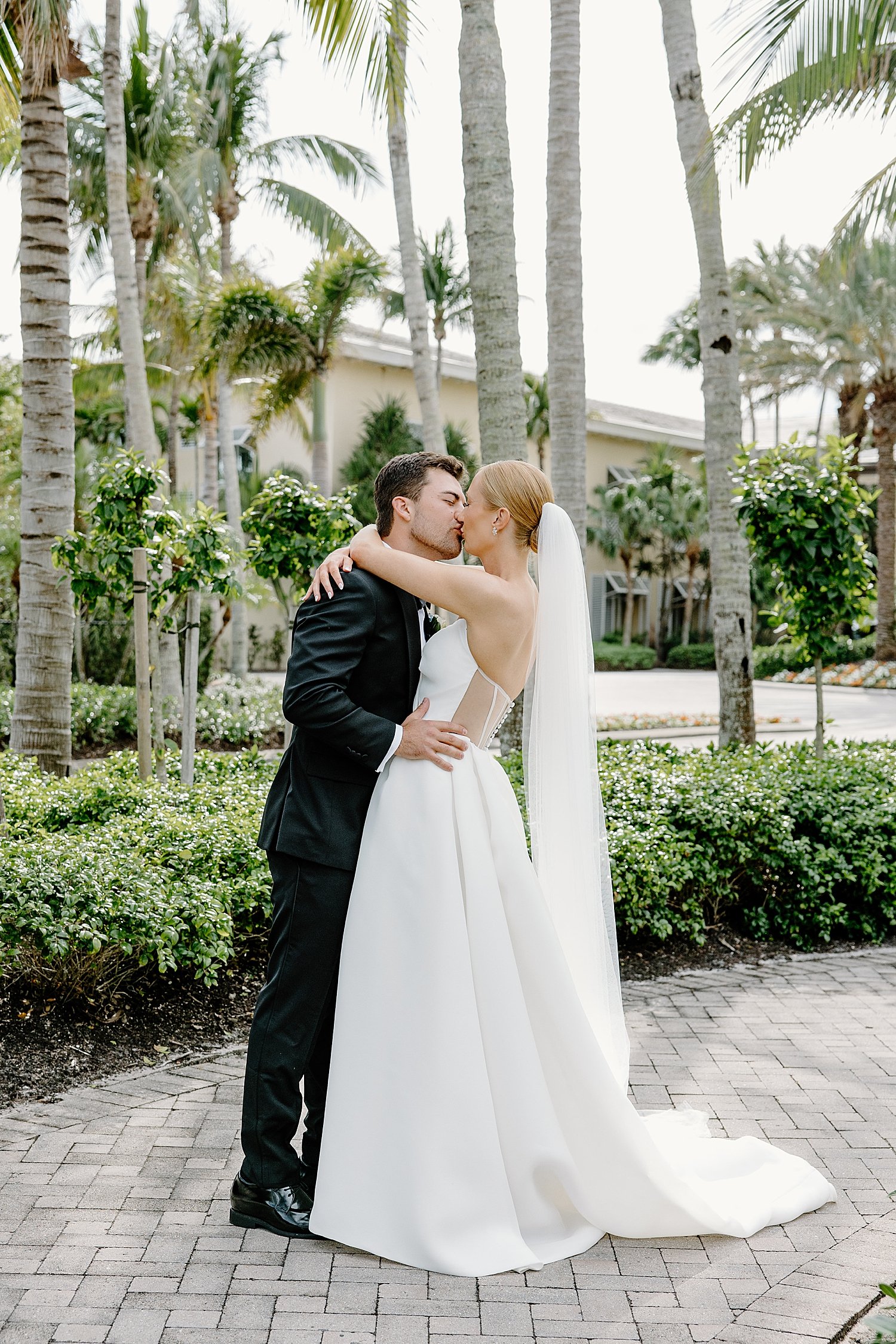 couple embraces after first look at Hyatt Regency Coconut Point