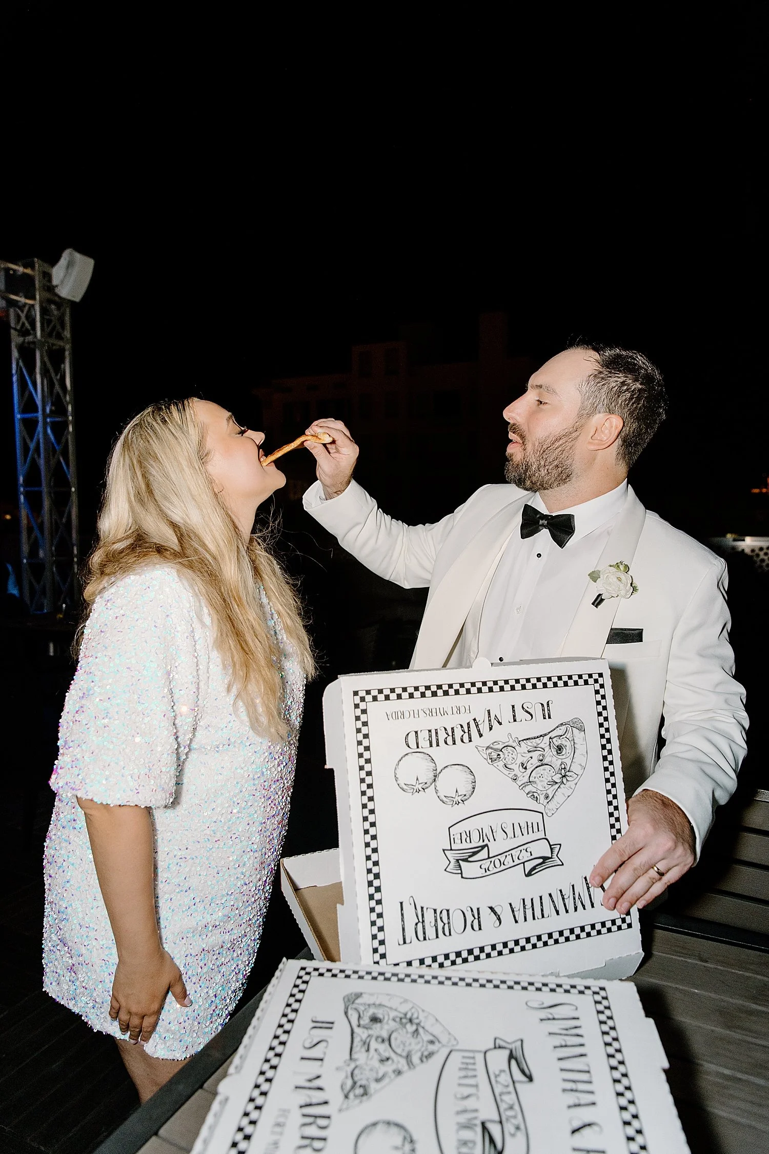 husband feeds wife pizza from custom box by Taylor Shea Photo
