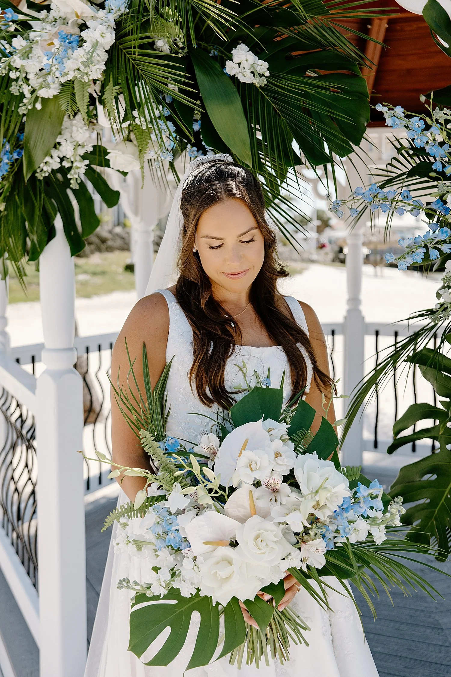 bride looks down at white florals by Taylor Shea Photo