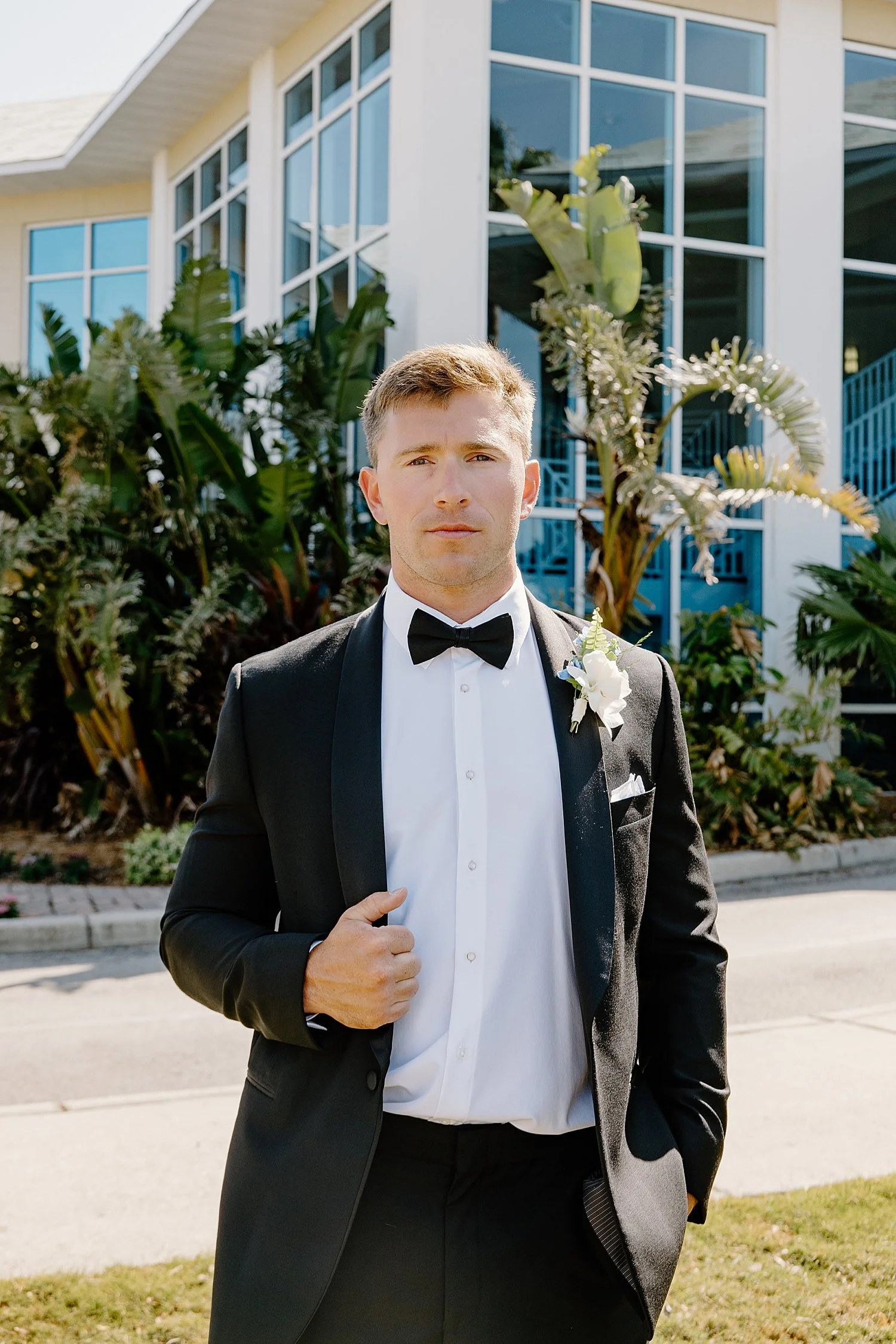 groom in black tux outside by Florida Wedding Photographer