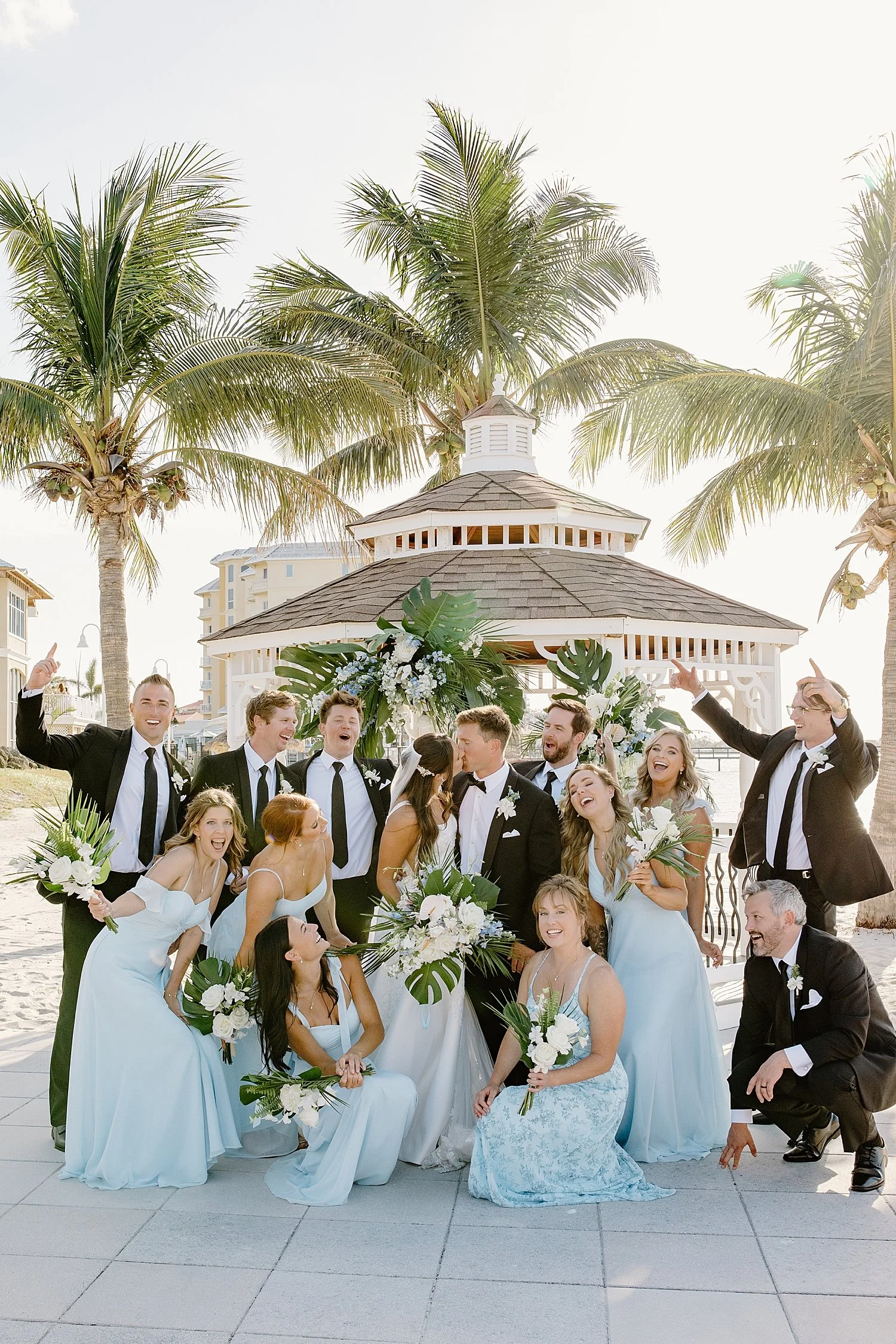 bridal party in blue and black surround newlyweds in celebration at Isla Del Sol Yacht and Country Club