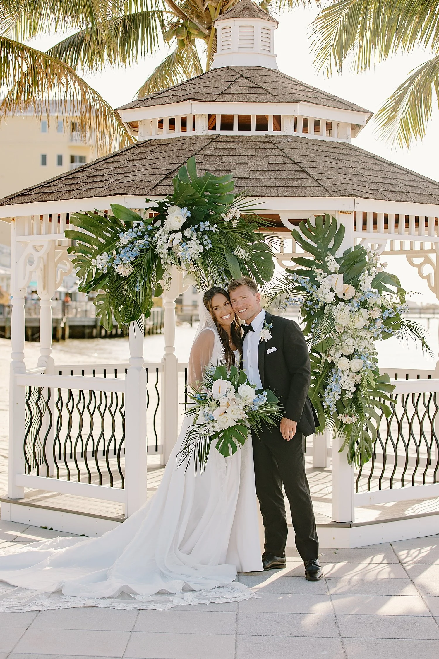 newlyweds grin in front of a gazebo by Taylor Shea Photo