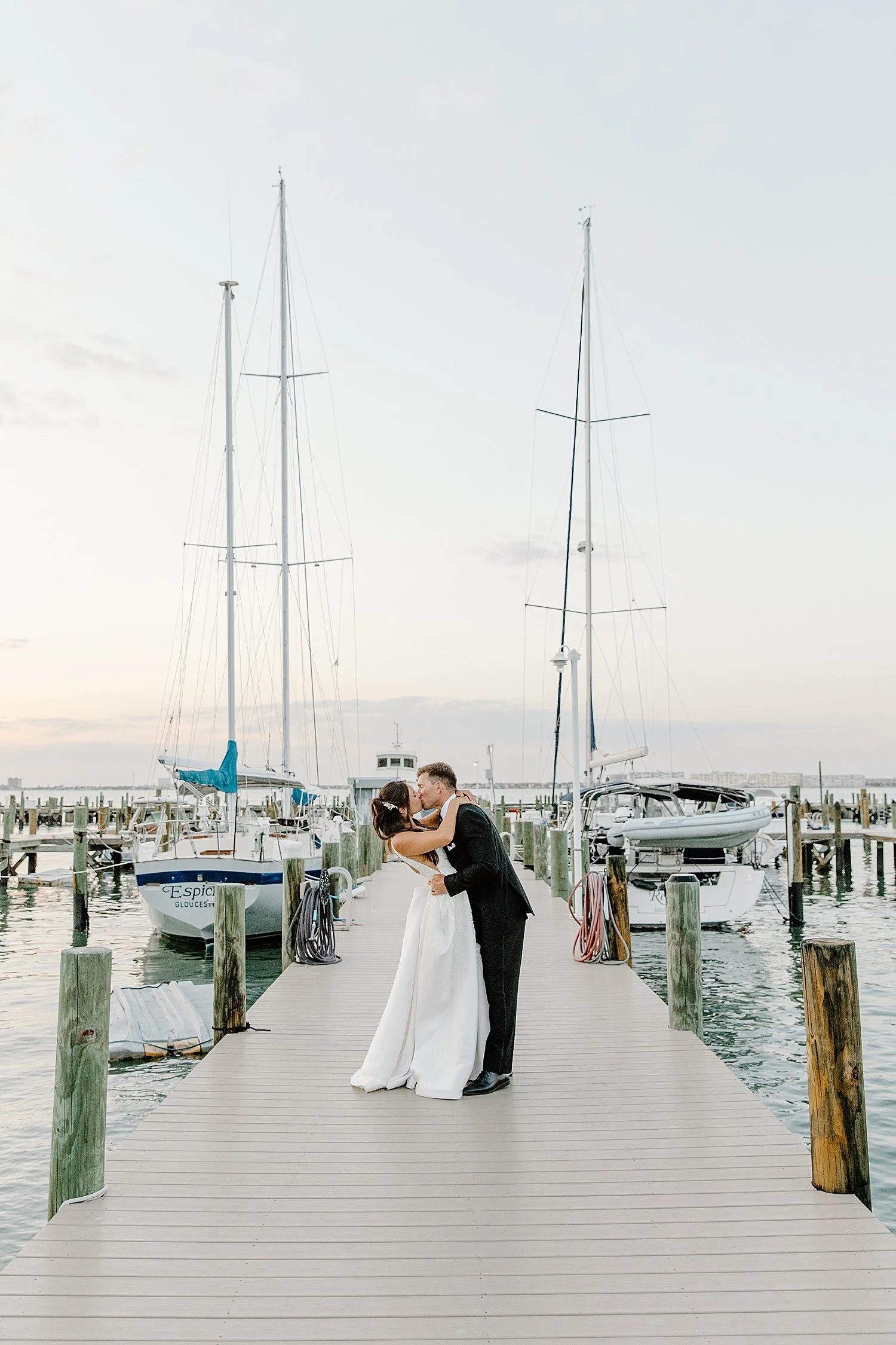 man and woman share a kiss on the dock at Isla Del Sol Yacht and Country Club
