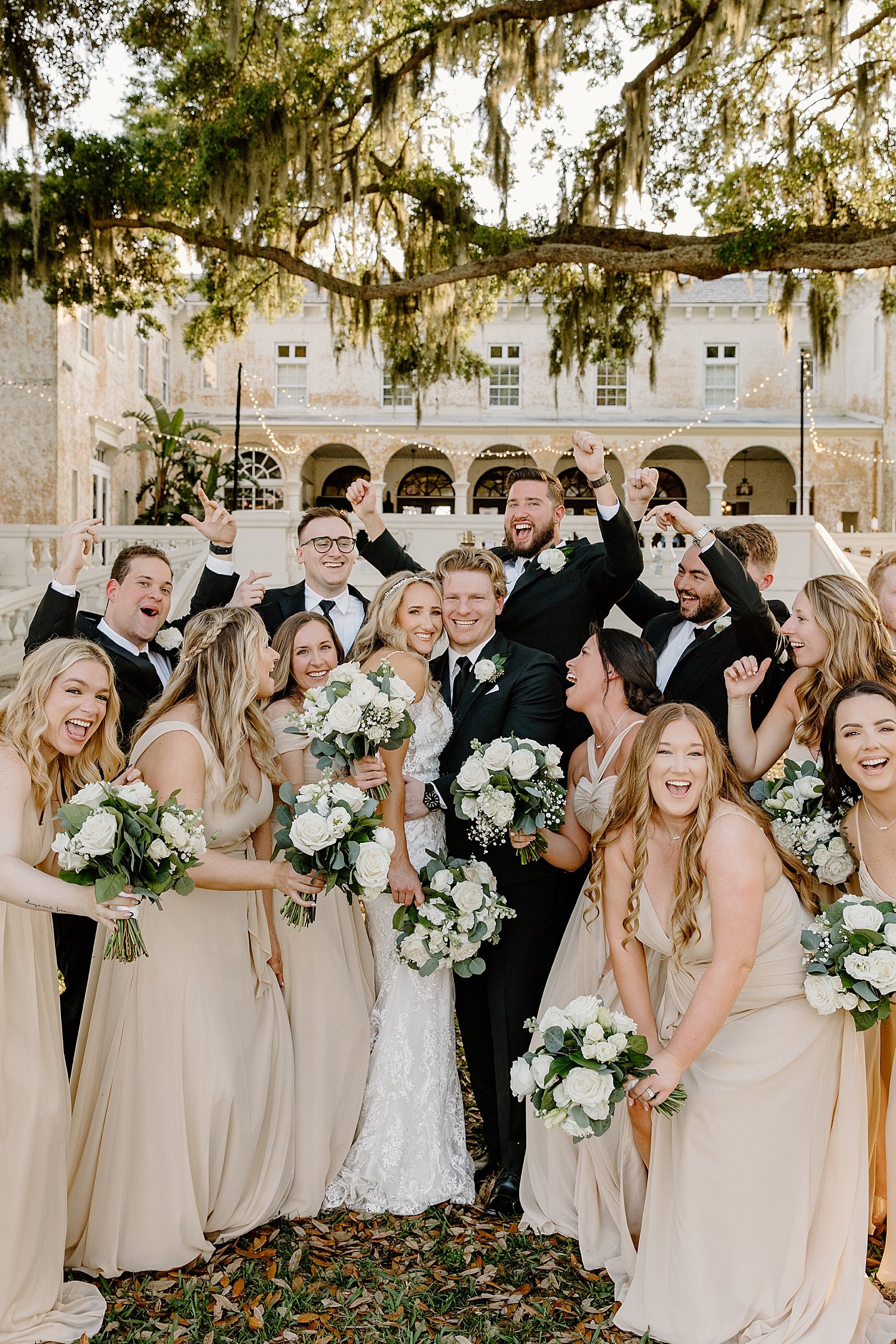 bridesmaids in blush pink and groomsmen in black surround couple by Taylor Shea Photo 