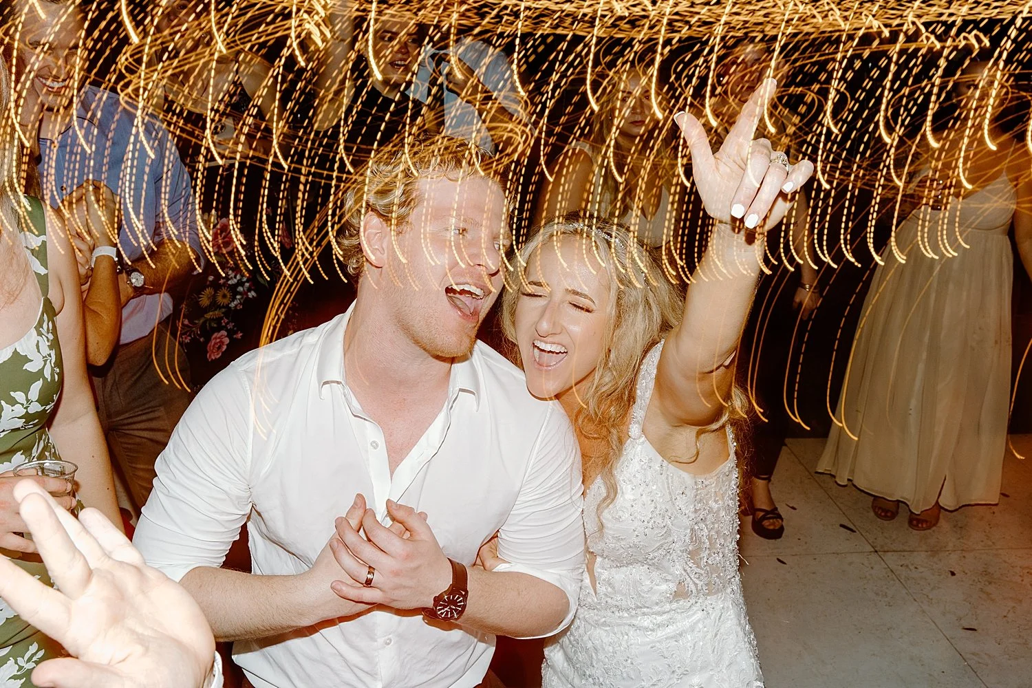 bride and groom dance under reception lights by Florida wedding photographer 