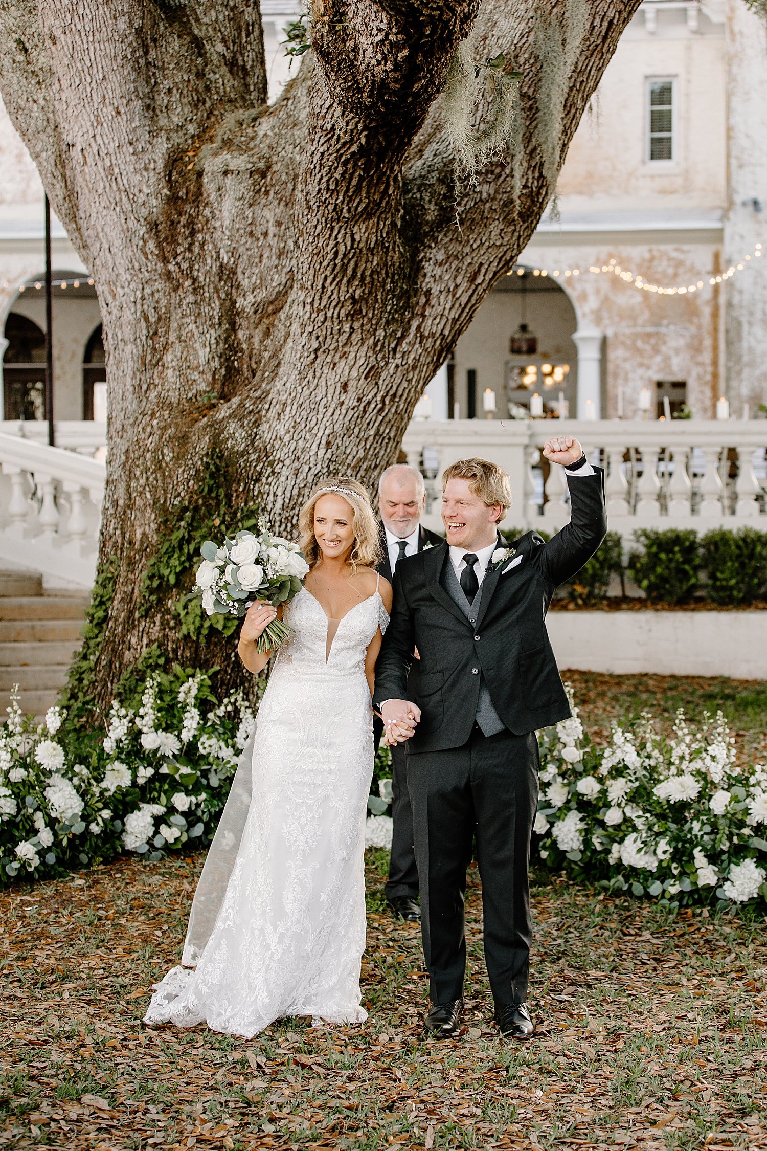  newlyweds pump fists in the air after saying I Do at the alter by Florida wedding photographer 