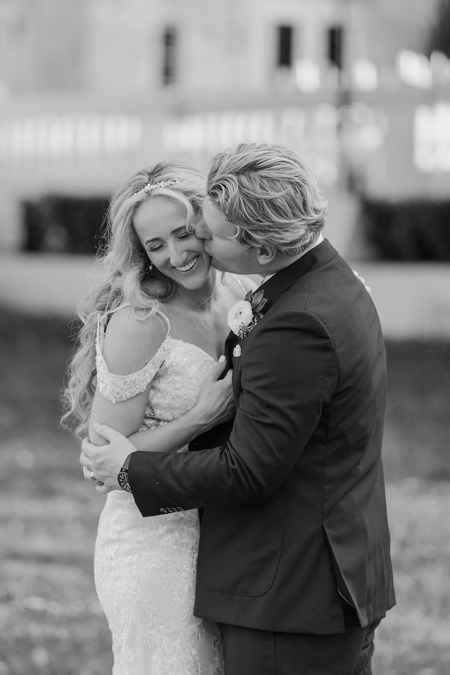 husband leans in to kiss new wife’s cheek after ceremony by Taylor Shea Photo 