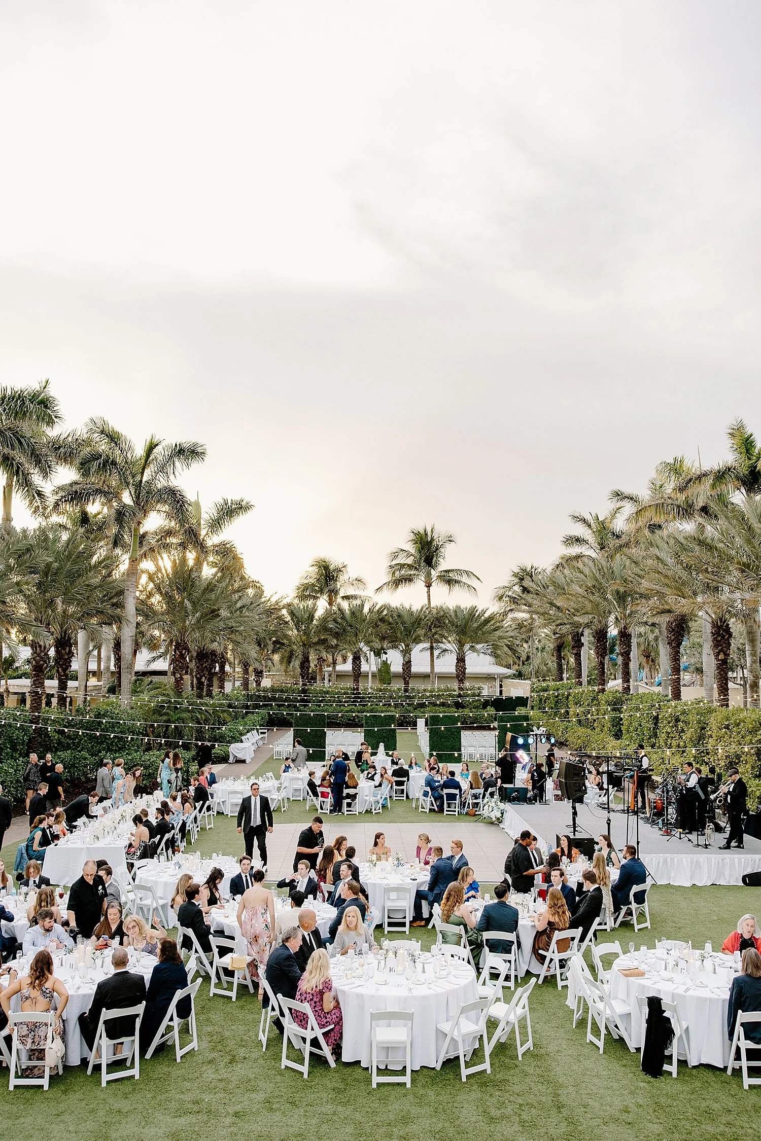  guests mingle at outdoor reception on lawn by Taylor Shea Photo 