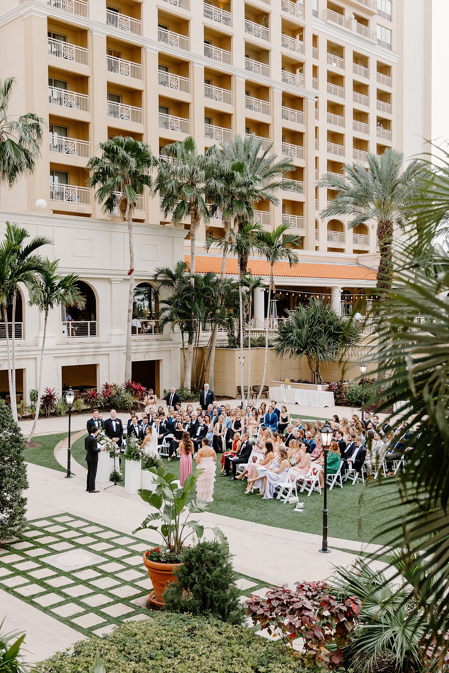  guests sit in chairs on the lawn by Taylor Shea Photo 