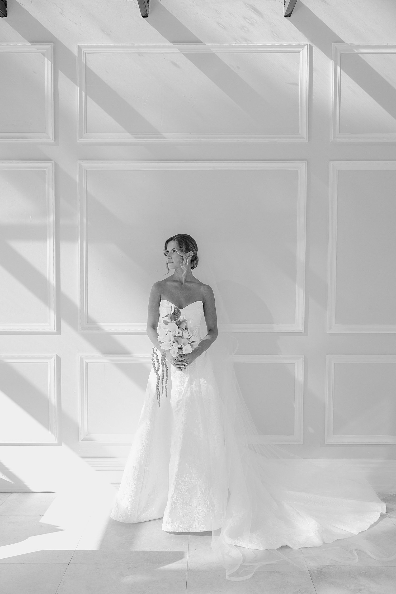  woman in white gown stands in front of white wall by Taylor Shea Photo 