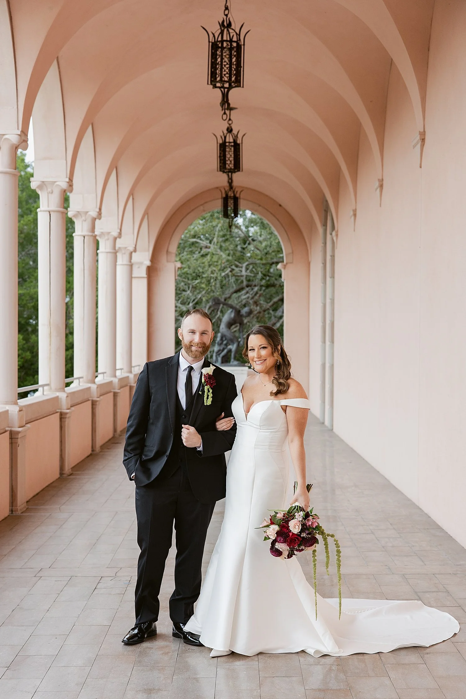  couple stands under archway for their courthouse elopement 