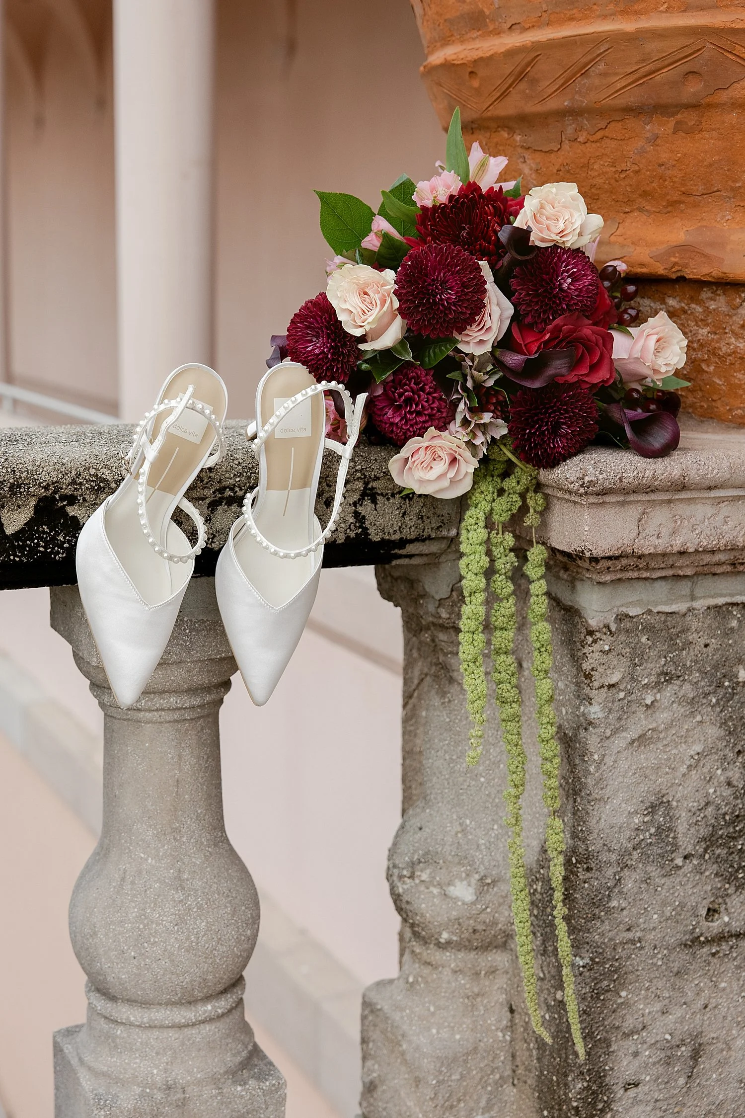  bridal heels perched on column next to bouquet by Taylor Shea Photo 