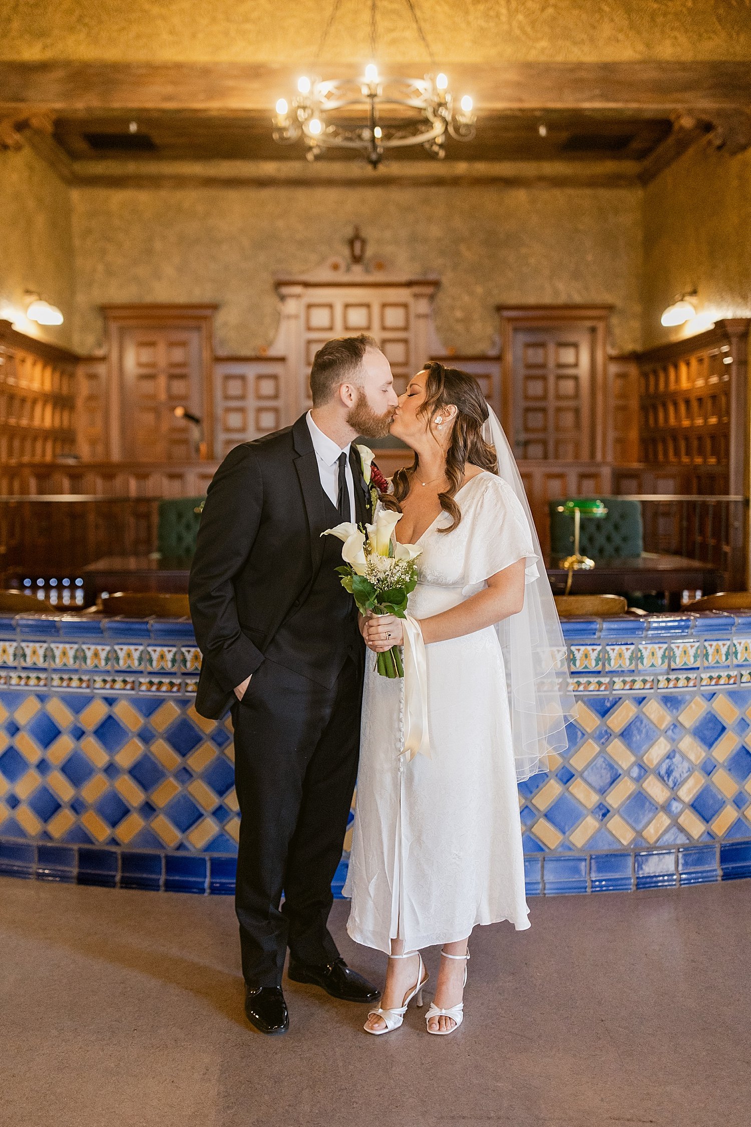  couple in formal attire in front of judge’s desk for their courthouse elopement 