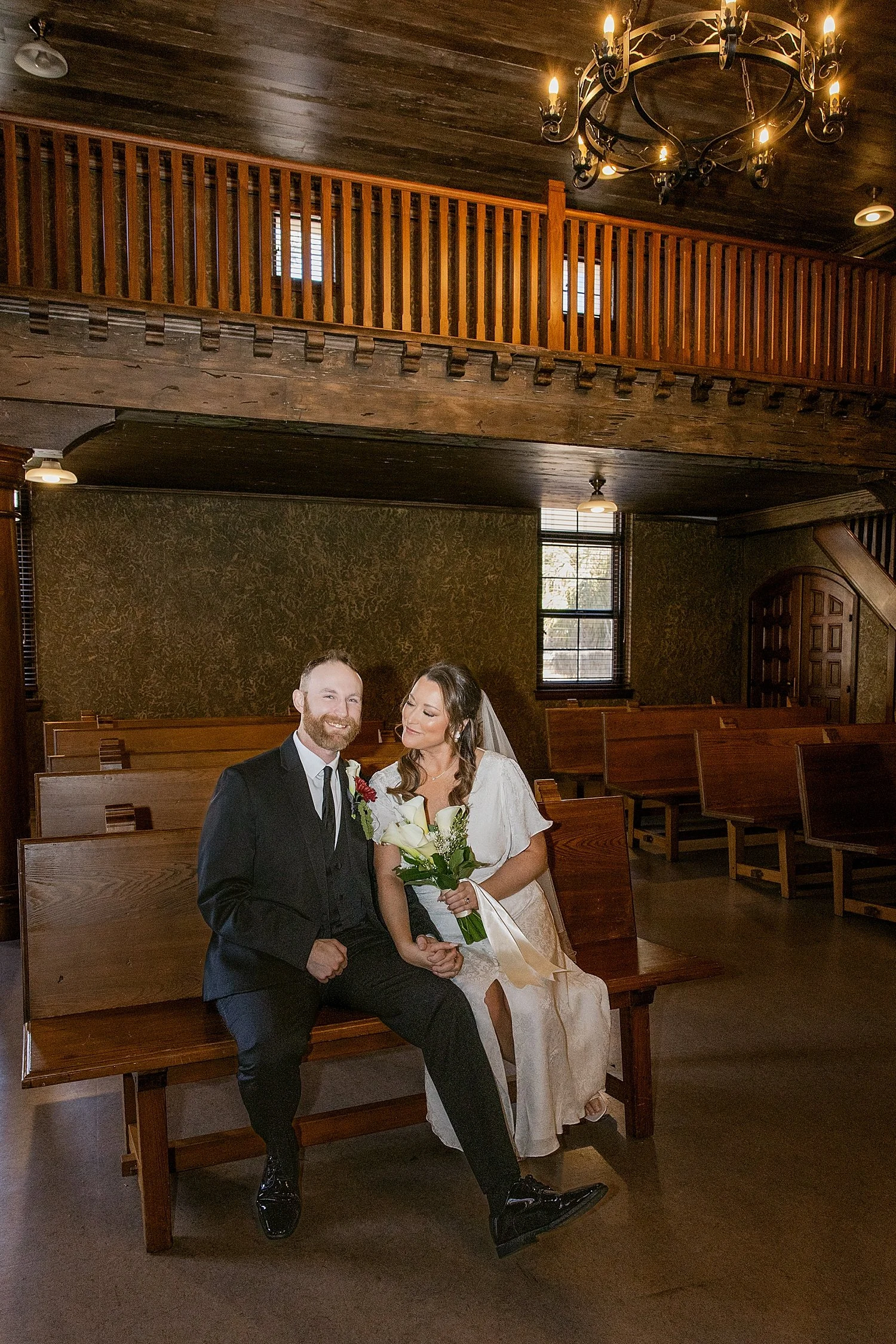  newlyweds sit on bench in courtroom after saying I Do by Taylor Shea Photo 