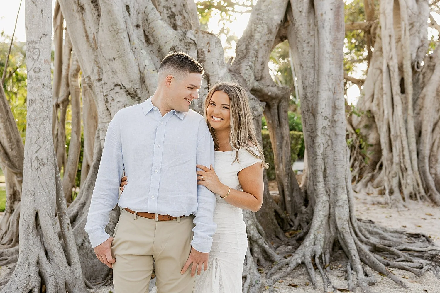  couple snuggle together under trees on Boca Grande Island 
