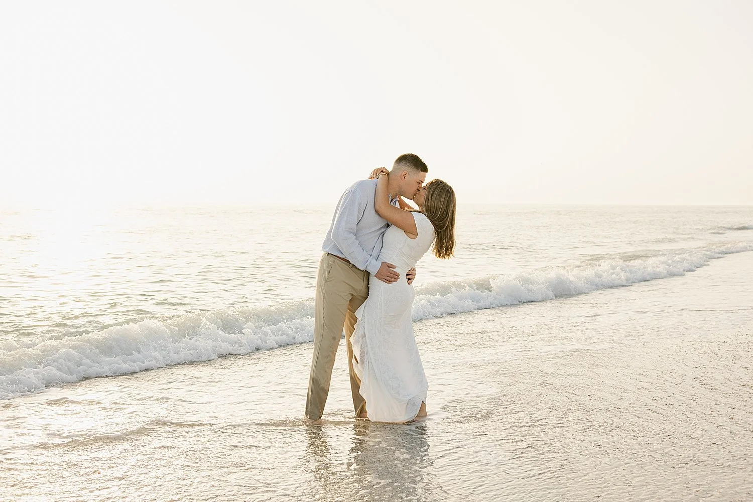  groom kisses his fiance standing in the water at Boca Grande Island 