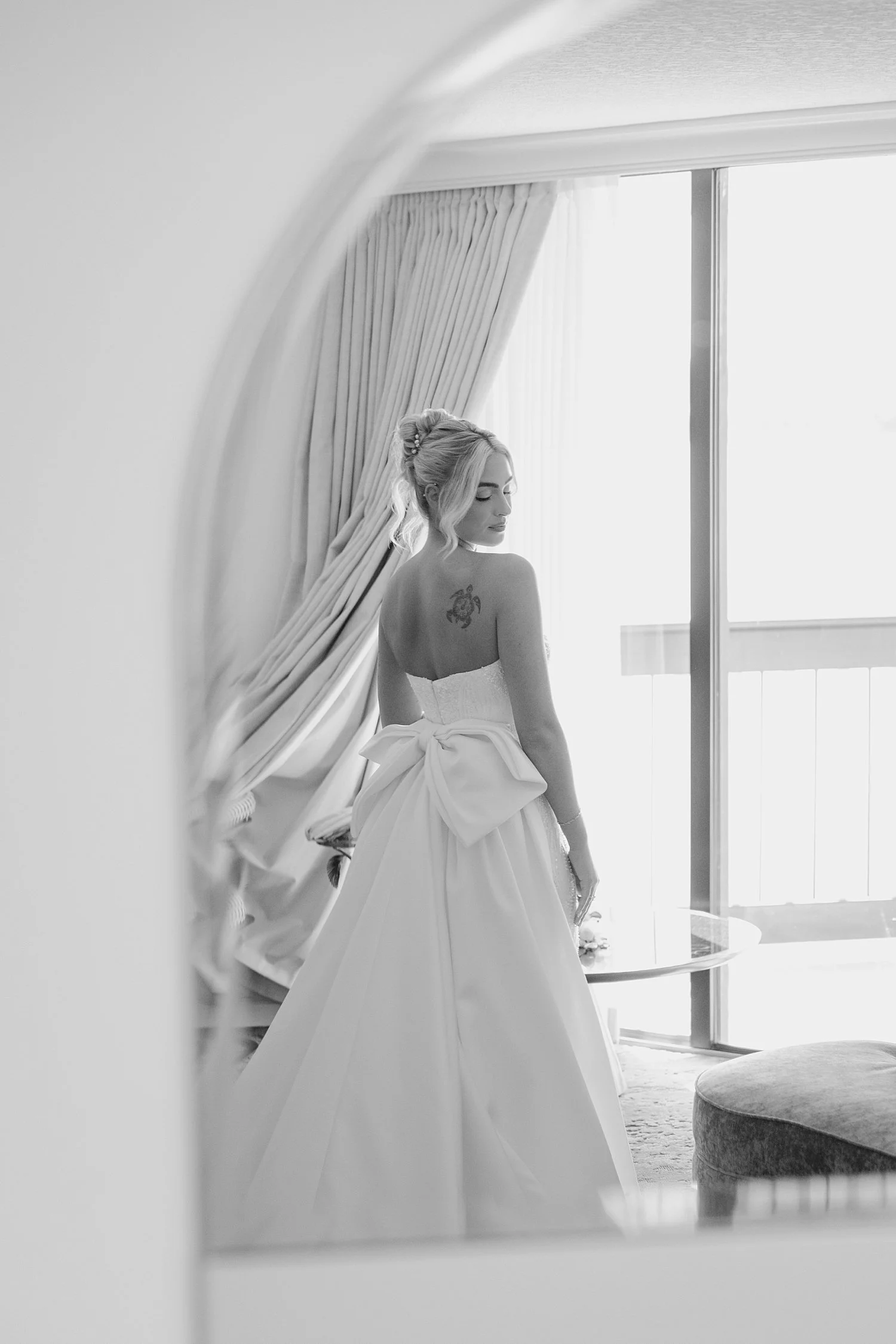  bride looks over her shoulder in front of a window by Taylor Shea Photo 