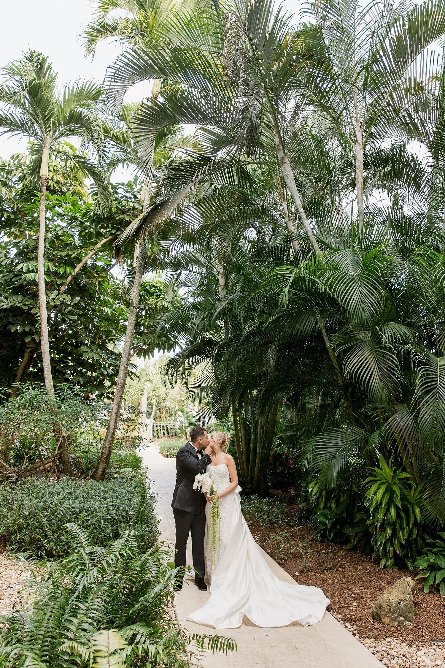  newlyweds walk through palm trees by Taylor Shea Photo 