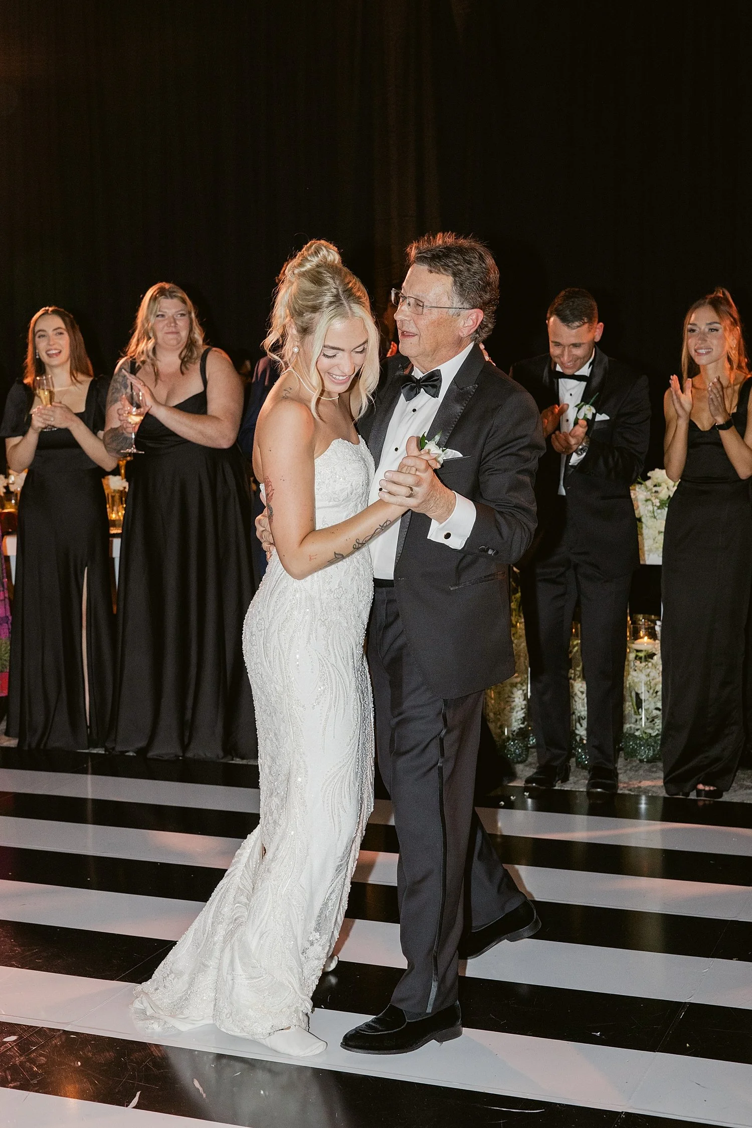  husband and wife share a first dance on checkered reception floor by Florida wedding photographer 