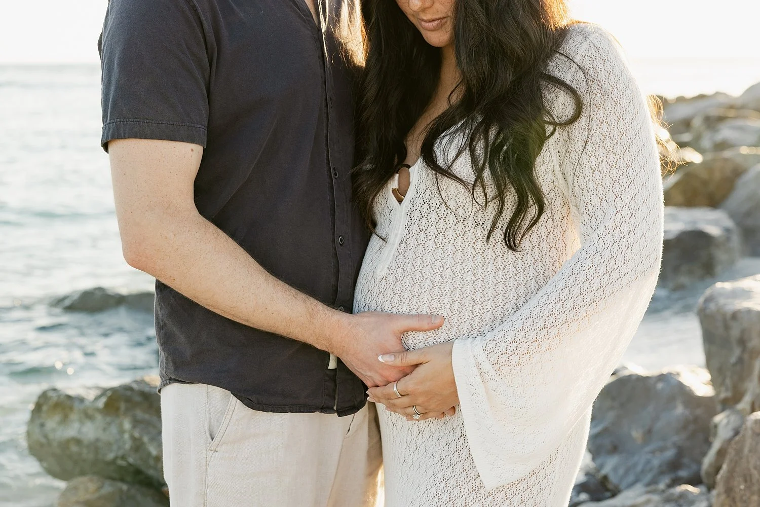  mom and dad place hands on expecting belly by Florida wedding photographer 