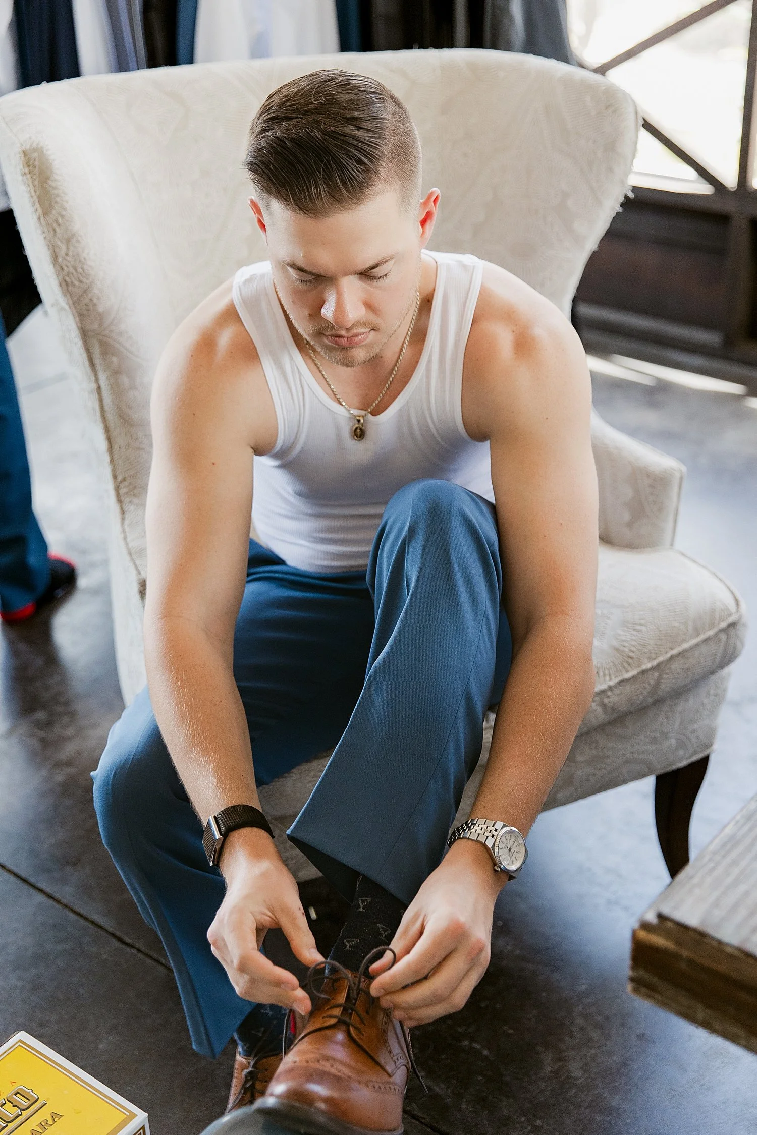  groom ties his shoes before ceremony at Mill Pond Estate 