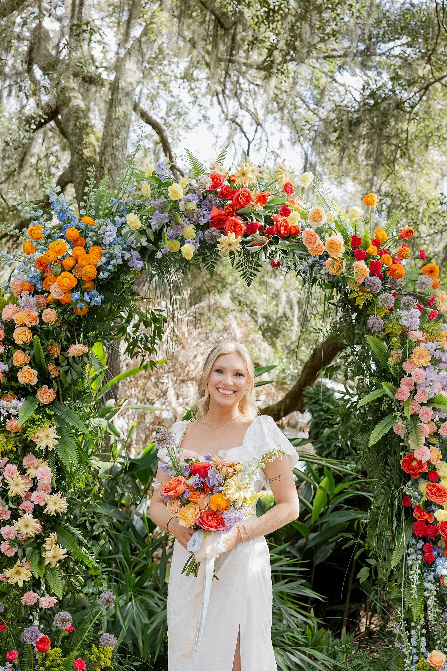  bride stands in front of colorful alter at Mill Pond Estate 