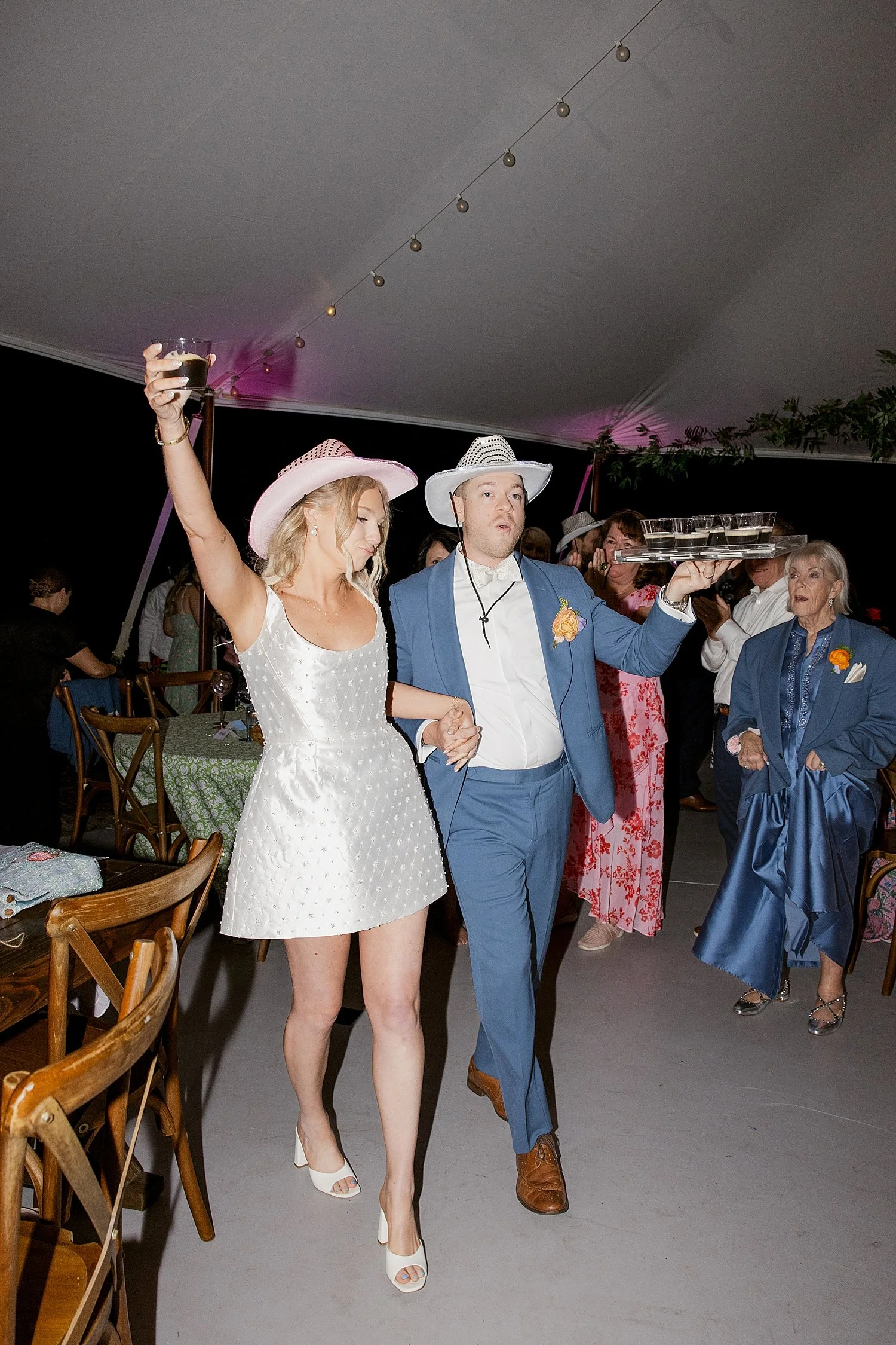  bride in mini dress and cowgirl hat show up to reception with her man by Taylor Shea Photo 