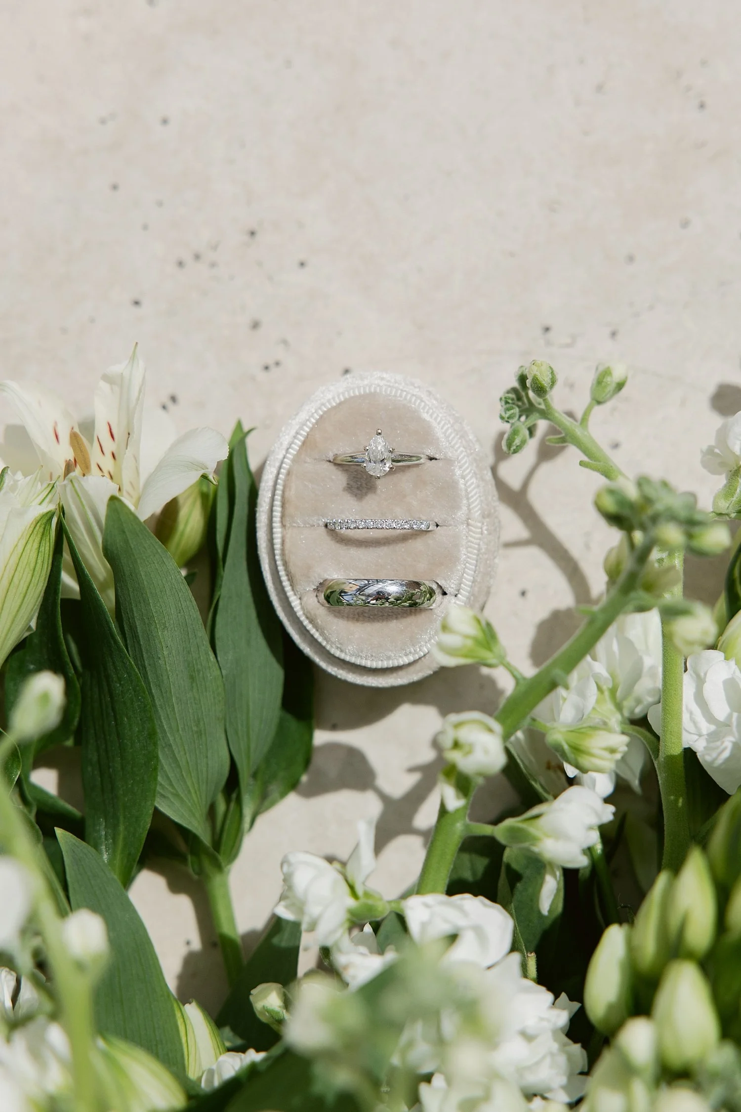  rings in an oval box laid out for ceremony + newlywed portraits 