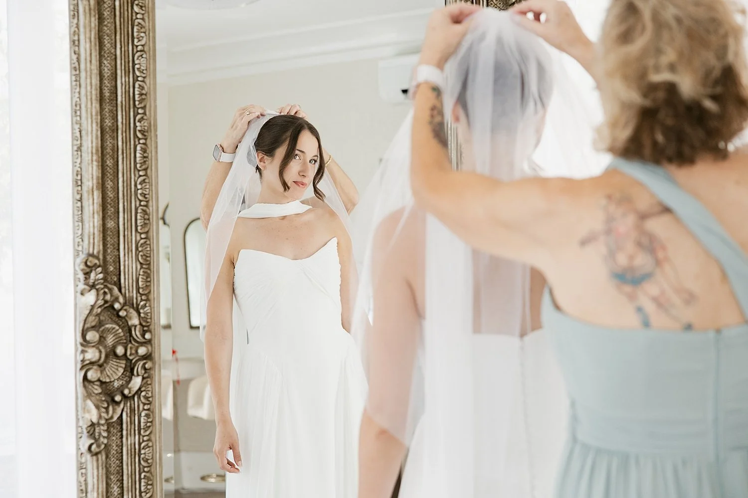  bride gets veil adjusted in mirror for ceremony + newlywed portraits 