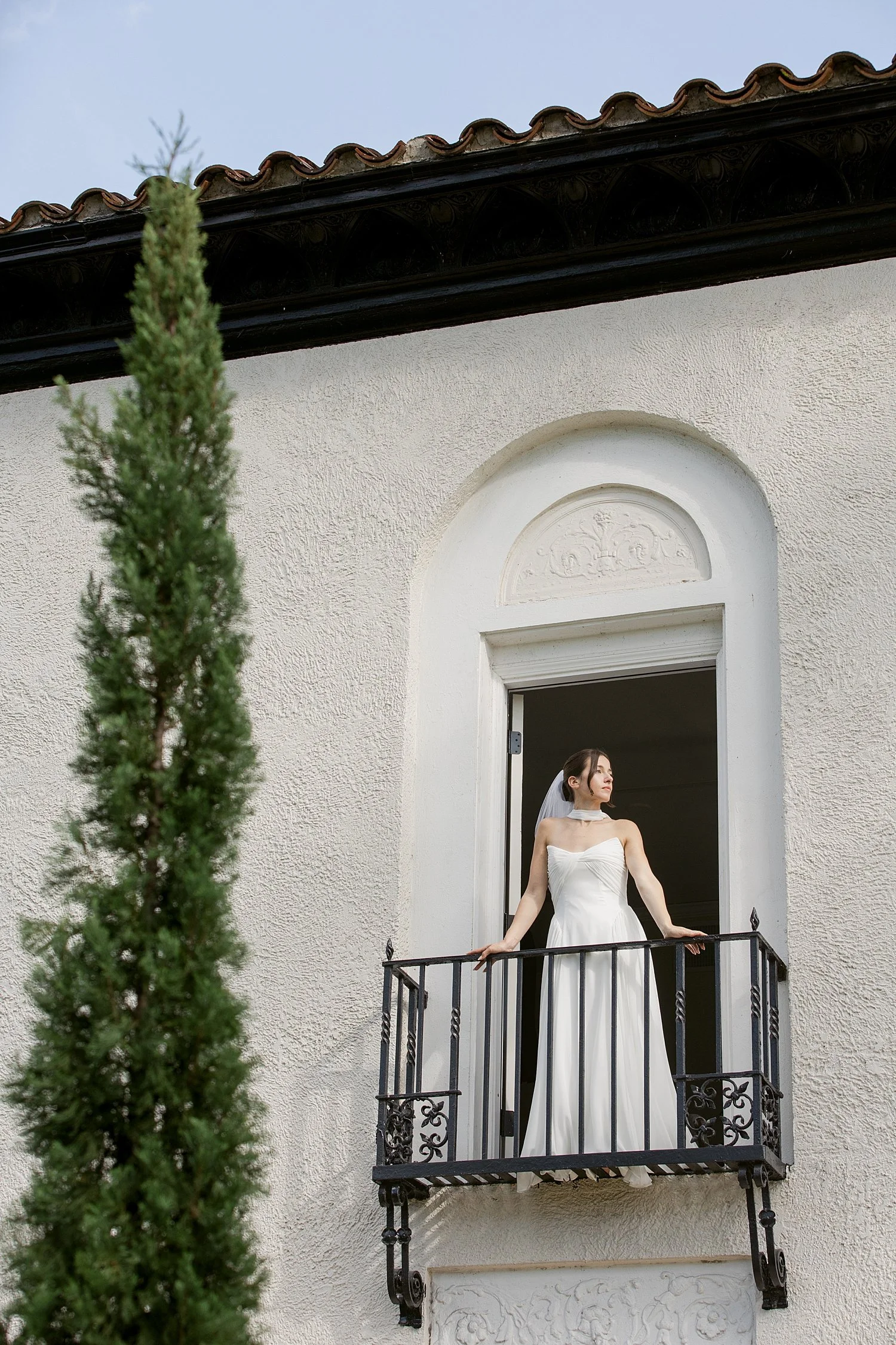  bride stands on balcony at Alderman house for ceremony + newlywed portraits 