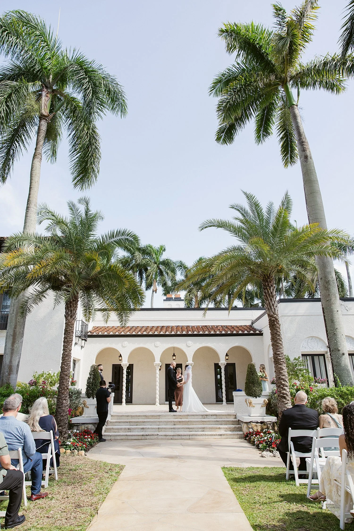  sweeping outdoor ceremony under palm trees by Florida wedding photographer 