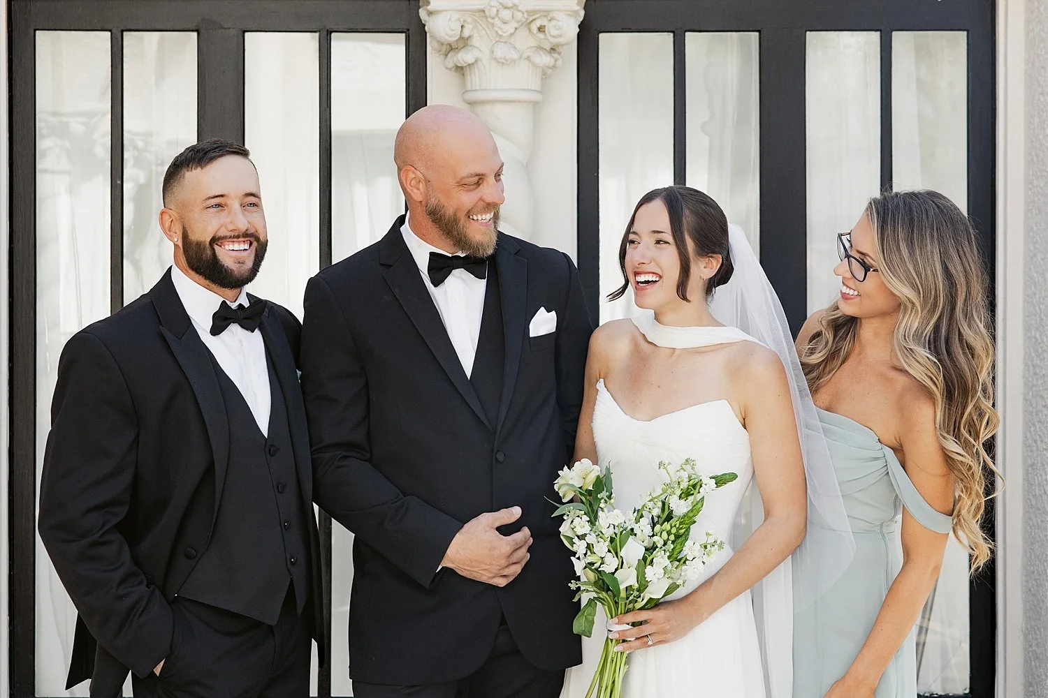  newlyweds stand with their best friends by Florida wedding photographer 