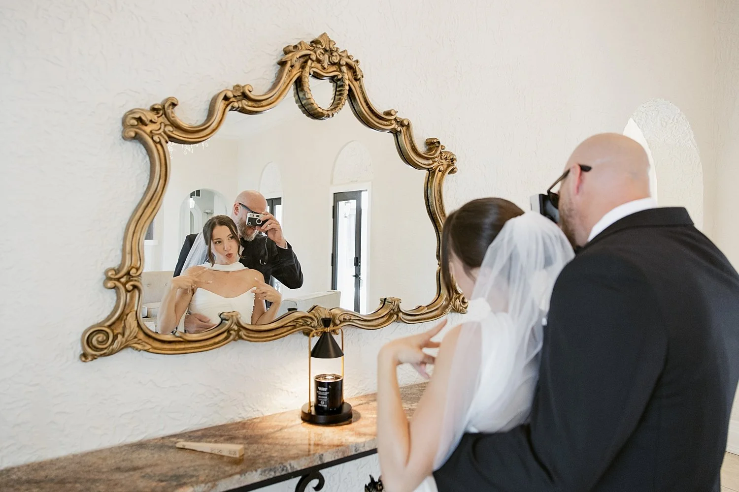  man takes photo of his new wife in gold mirror by Taylor Shea Photo 