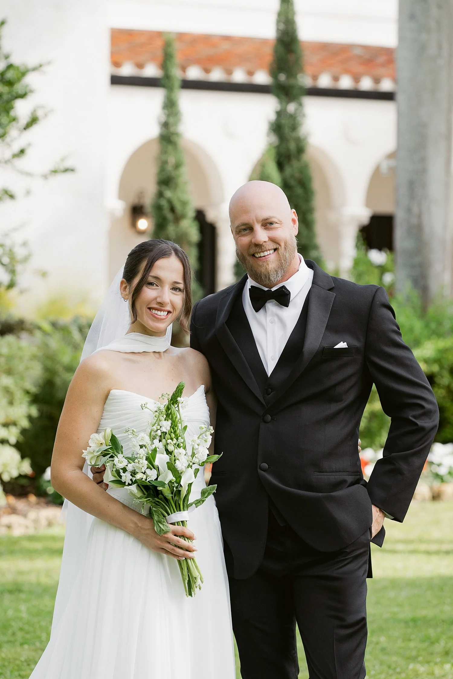  man and woman stand in front of alderman house after getting married for their ceremony + newlywed portraits 