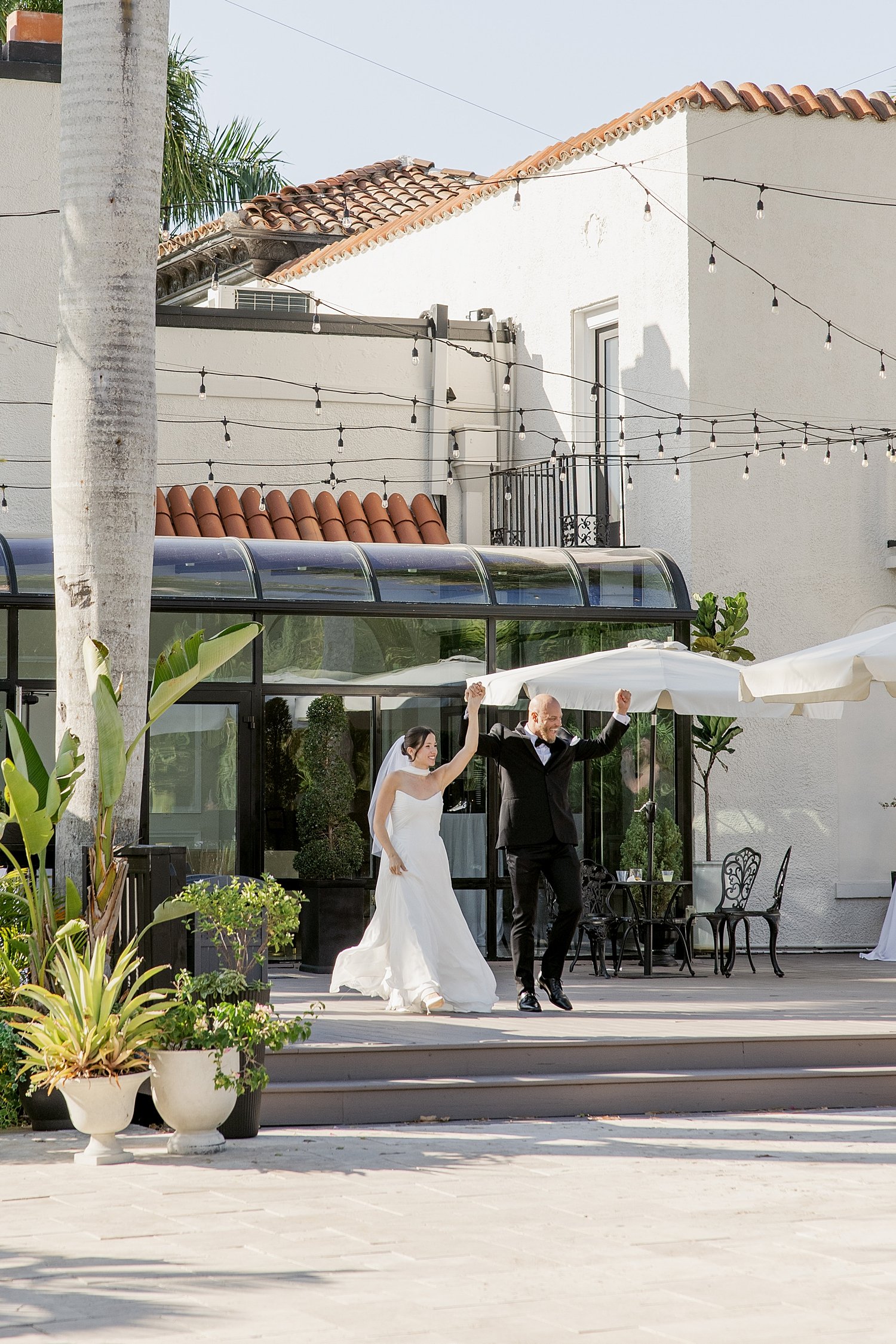 couple enter reception with hands in the air after ceremony + newlywed portraits 