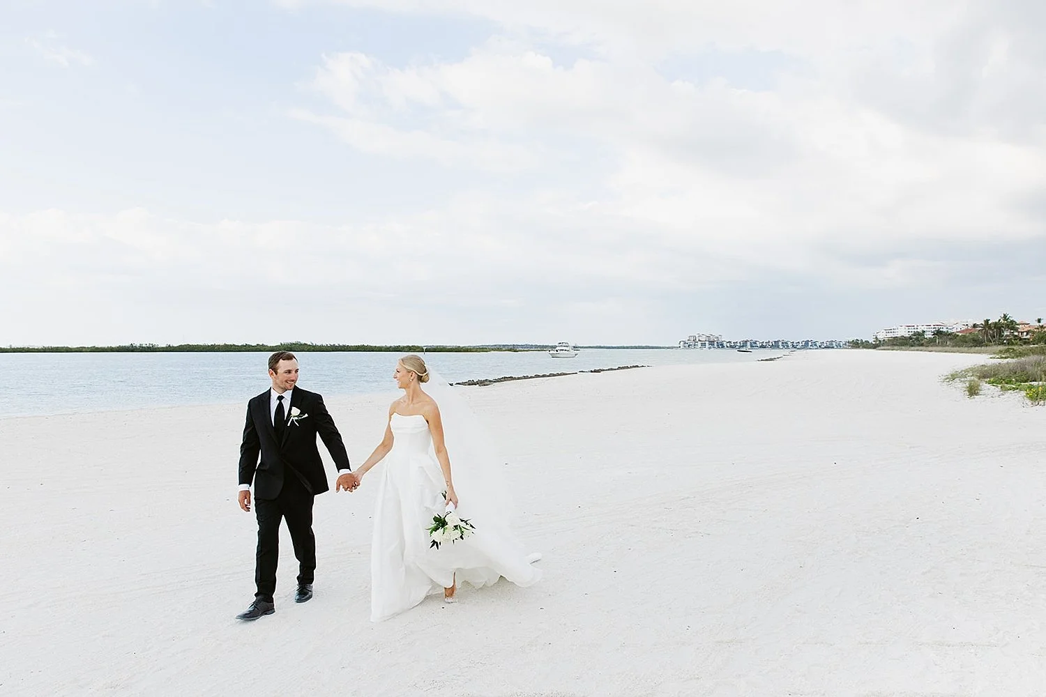  man and woman walk down the beach together by Taylor Shea Photo 