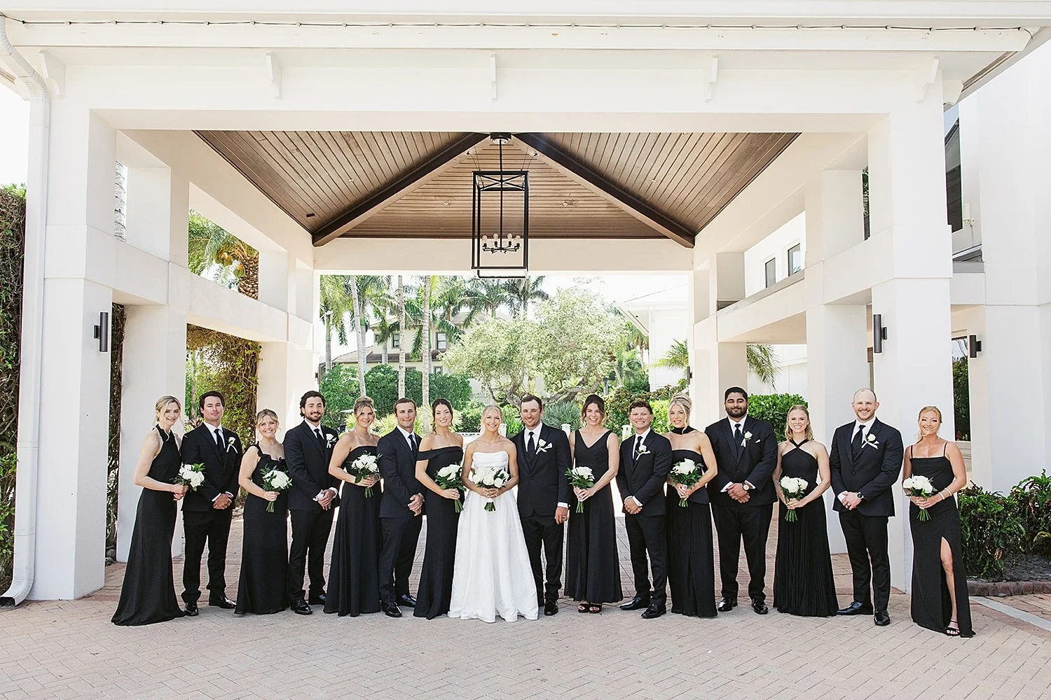  bride and groom stand with bridal party by Florida wedding photographer 
