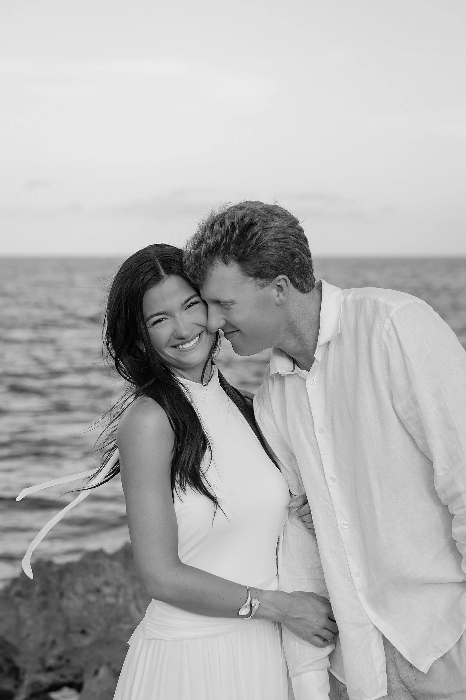  man leans in to his fiancé while they giggle together by Taylor Shea Photo 