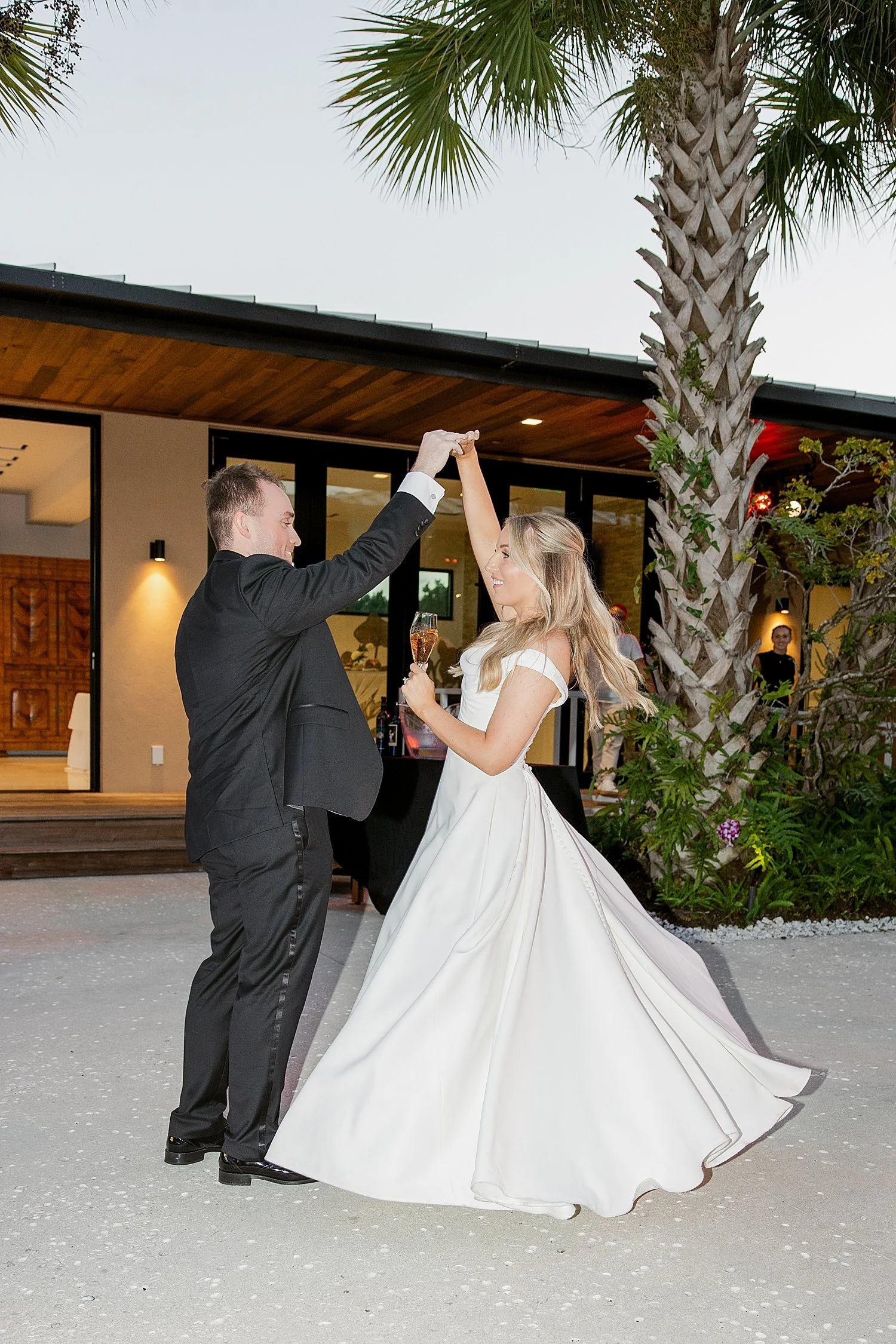  groom spins bride on dance floor by Florida photographer 