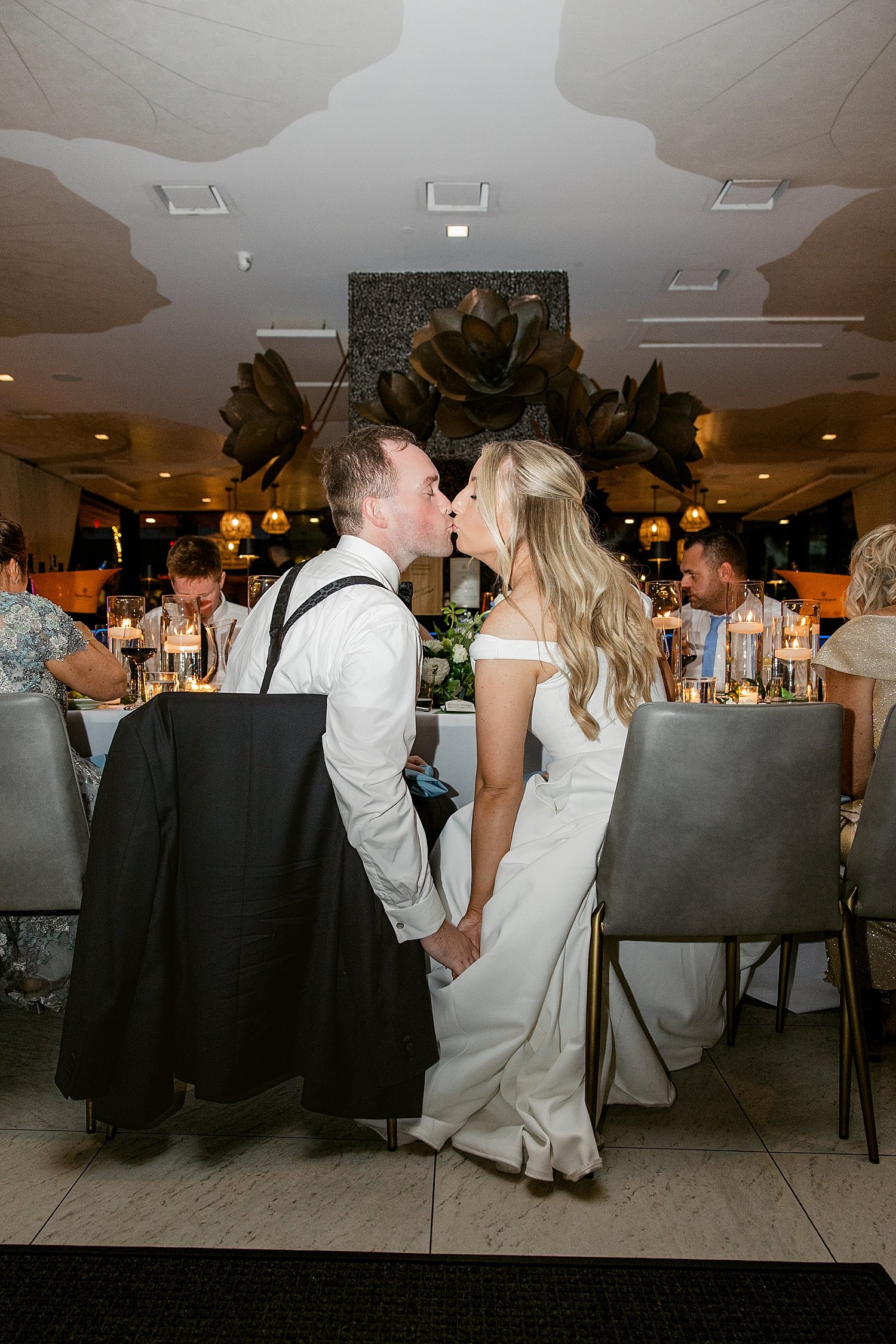  bride and groom kiss during their reception dinner by Taylor Shea Photography 