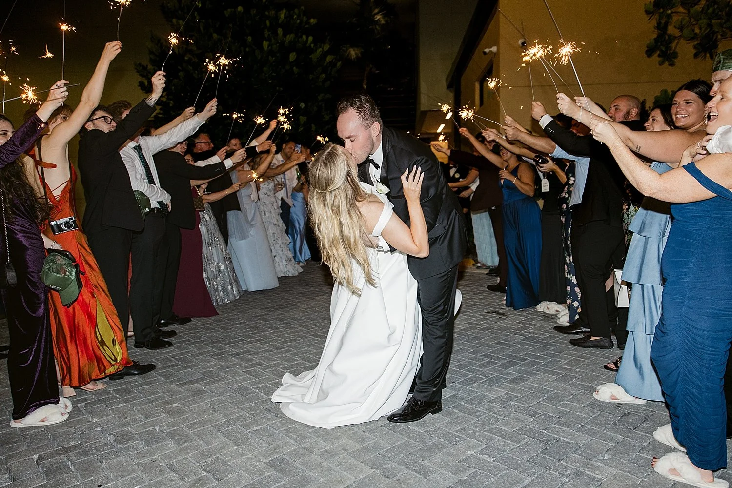  newlyweds dip for a kiss during sparkler exit by Florida photographer 