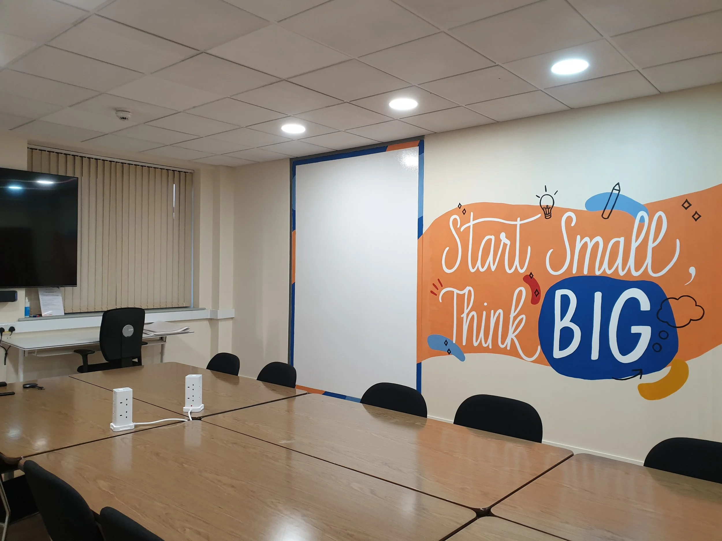 colourful lettering mural in office meeting room