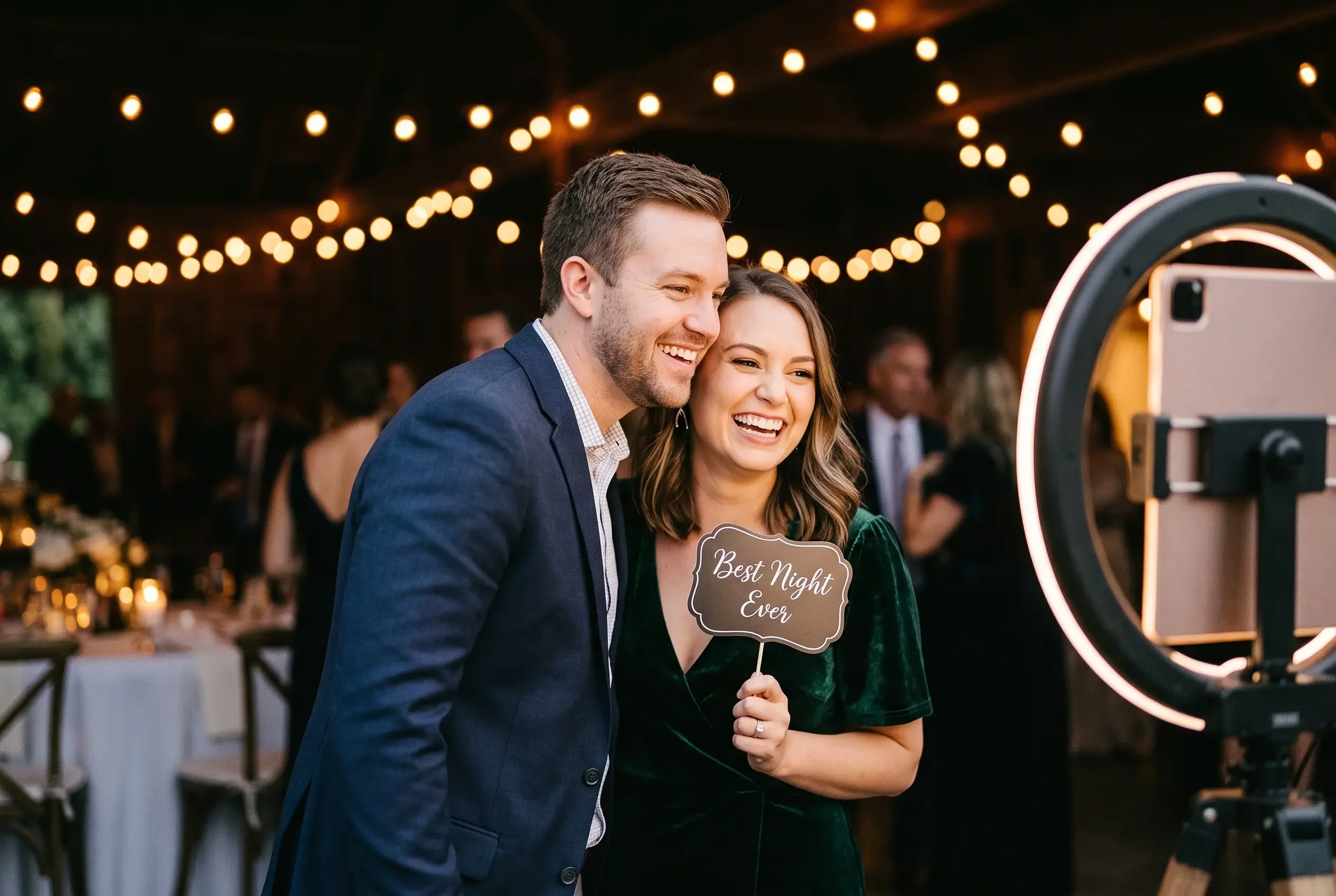 Two guests evenly lit by a soft photo booth light, showing flattering, even lighting on their faces.