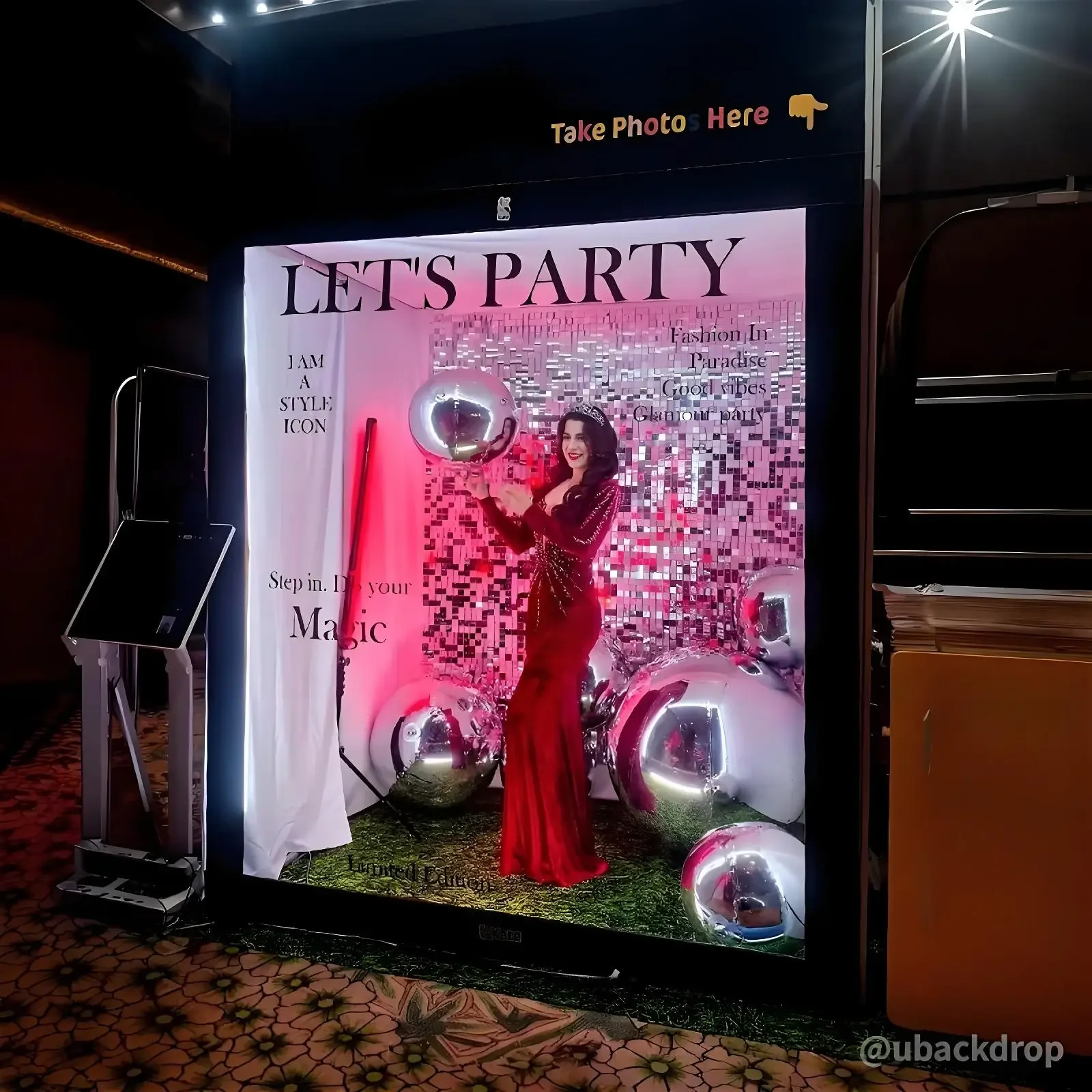 a themed photo booth setup next to inflatable balls