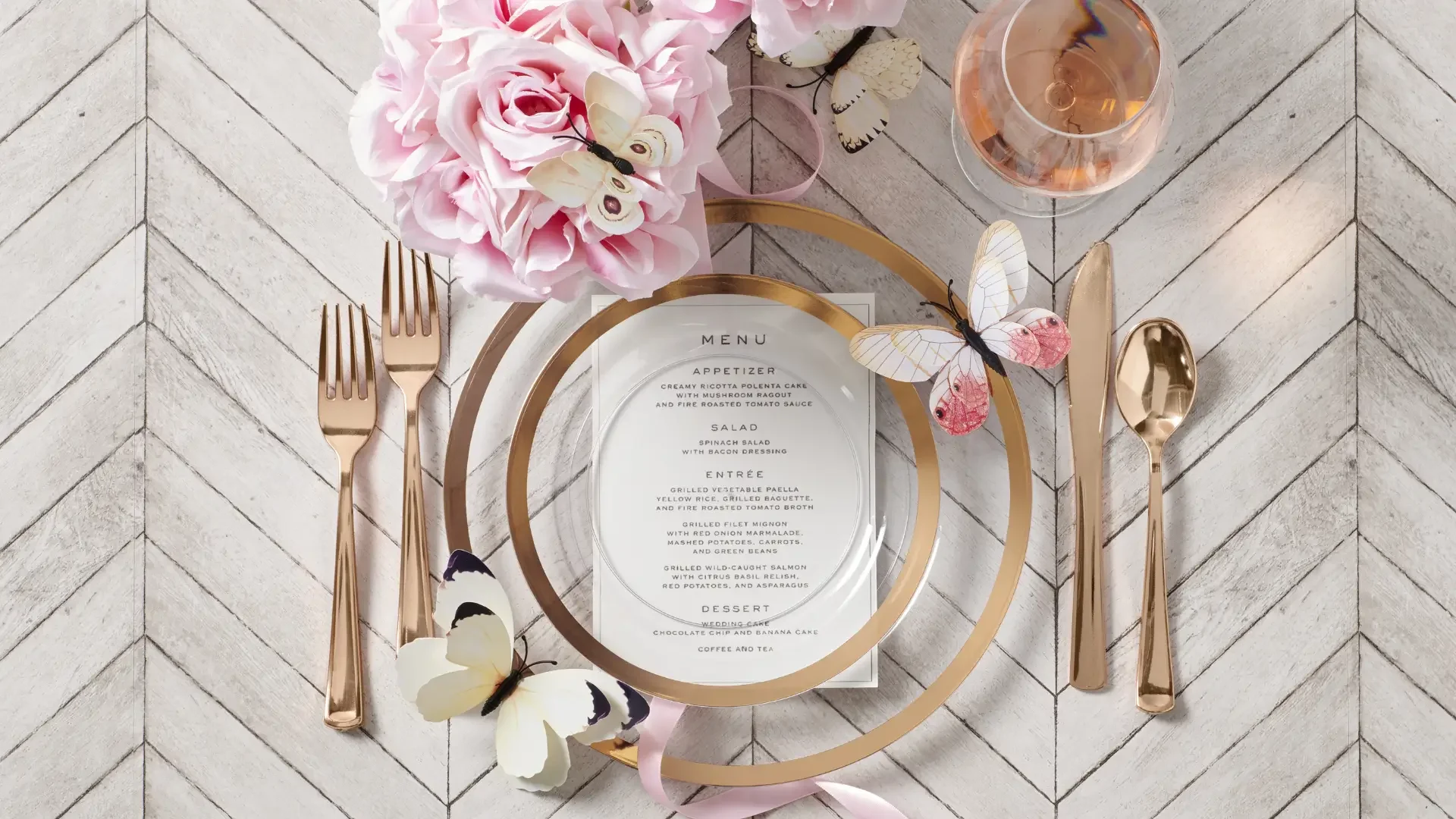 A close-up of a scalloped, gold-rimmed dinner plate on a linen tablecloth.