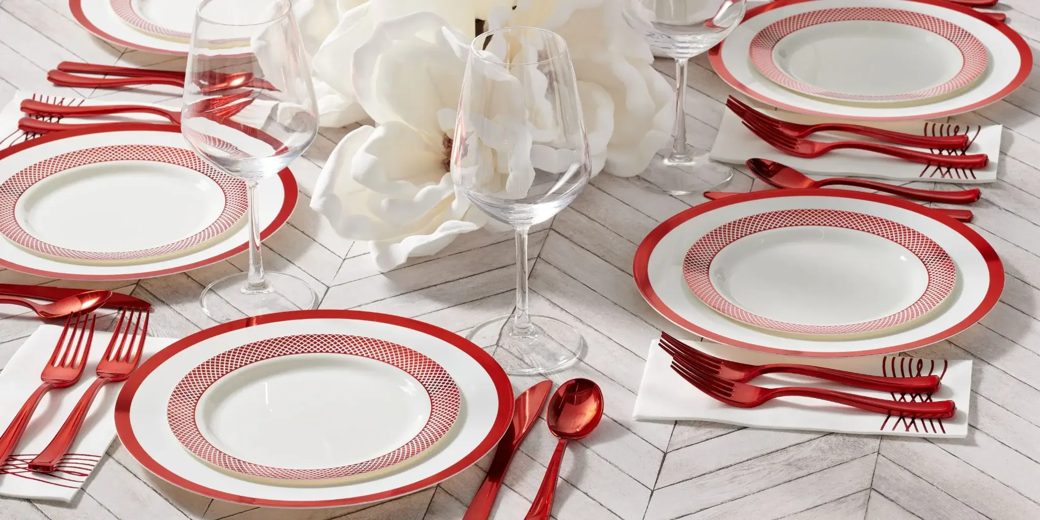A single wedding place setting with a folded napkin, cutlery, and a real wine glass in candlelight.